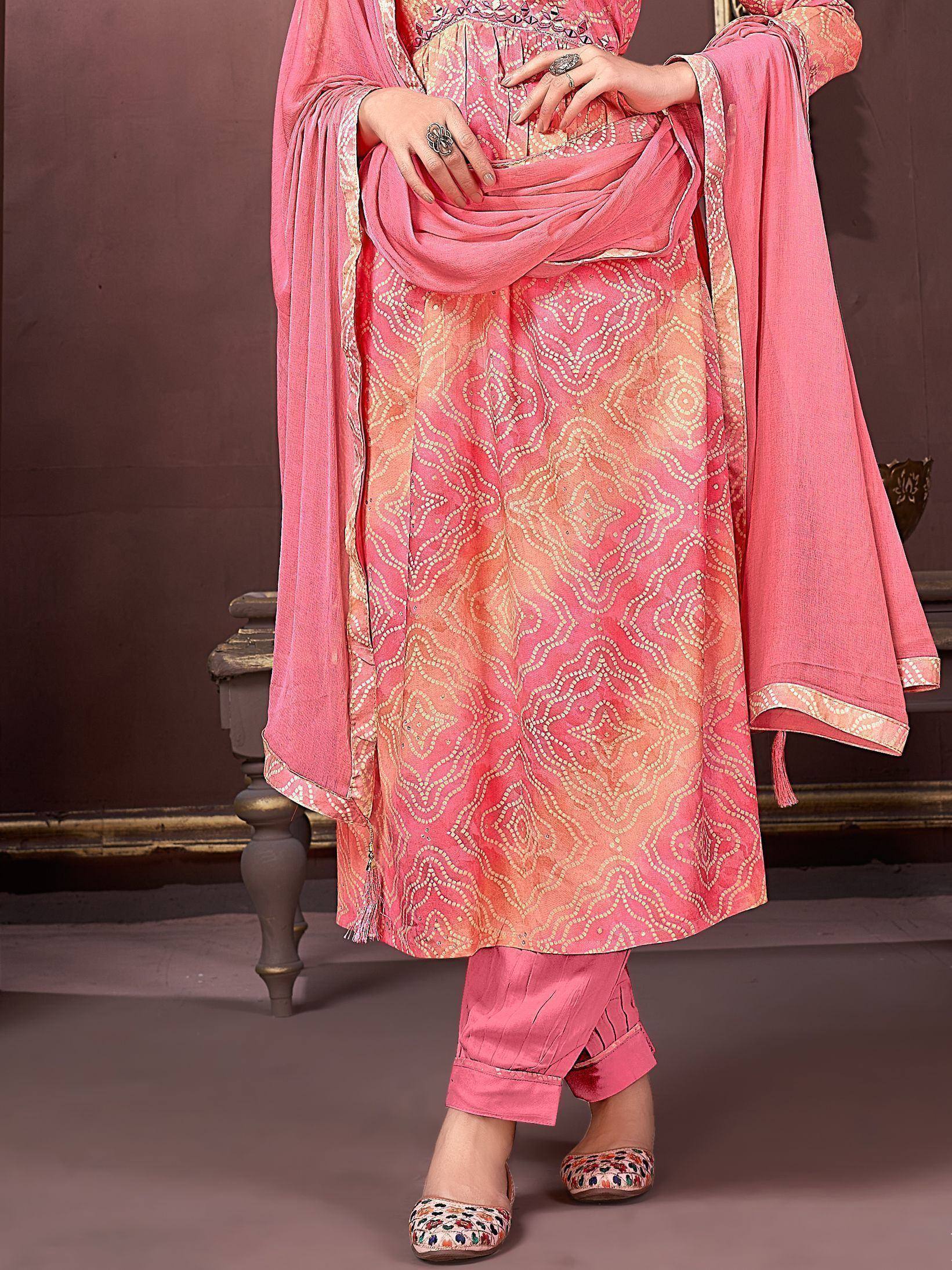 Pink ethnic salwar kameez with gold geometric print, matching dupatta, and embroidered flats