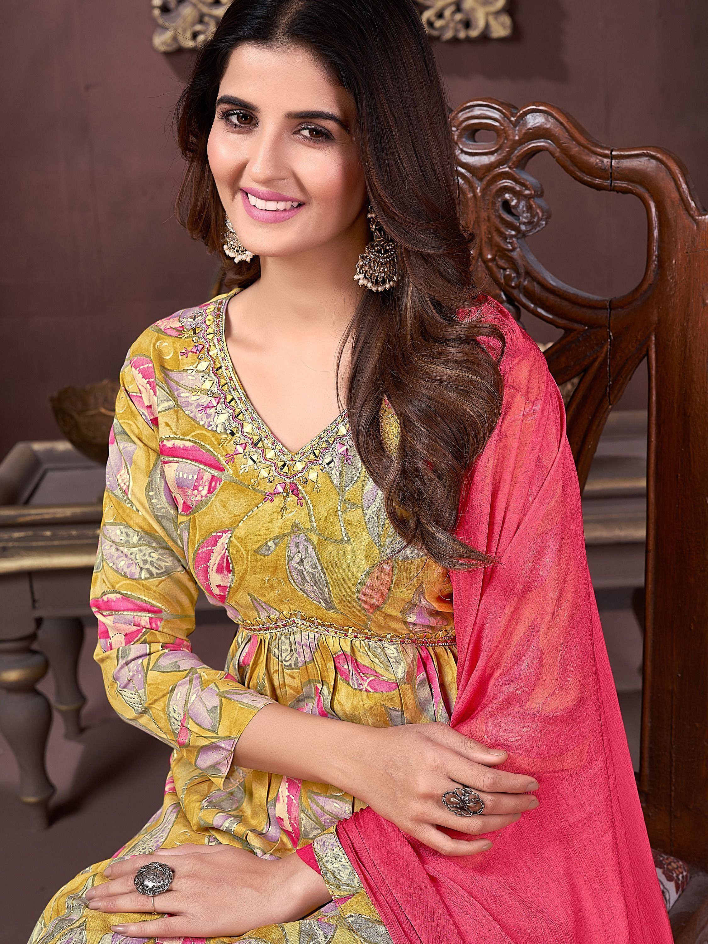 Woman in yellow floral printed ethnic gown with pink dupatta, styled for Indian occasions