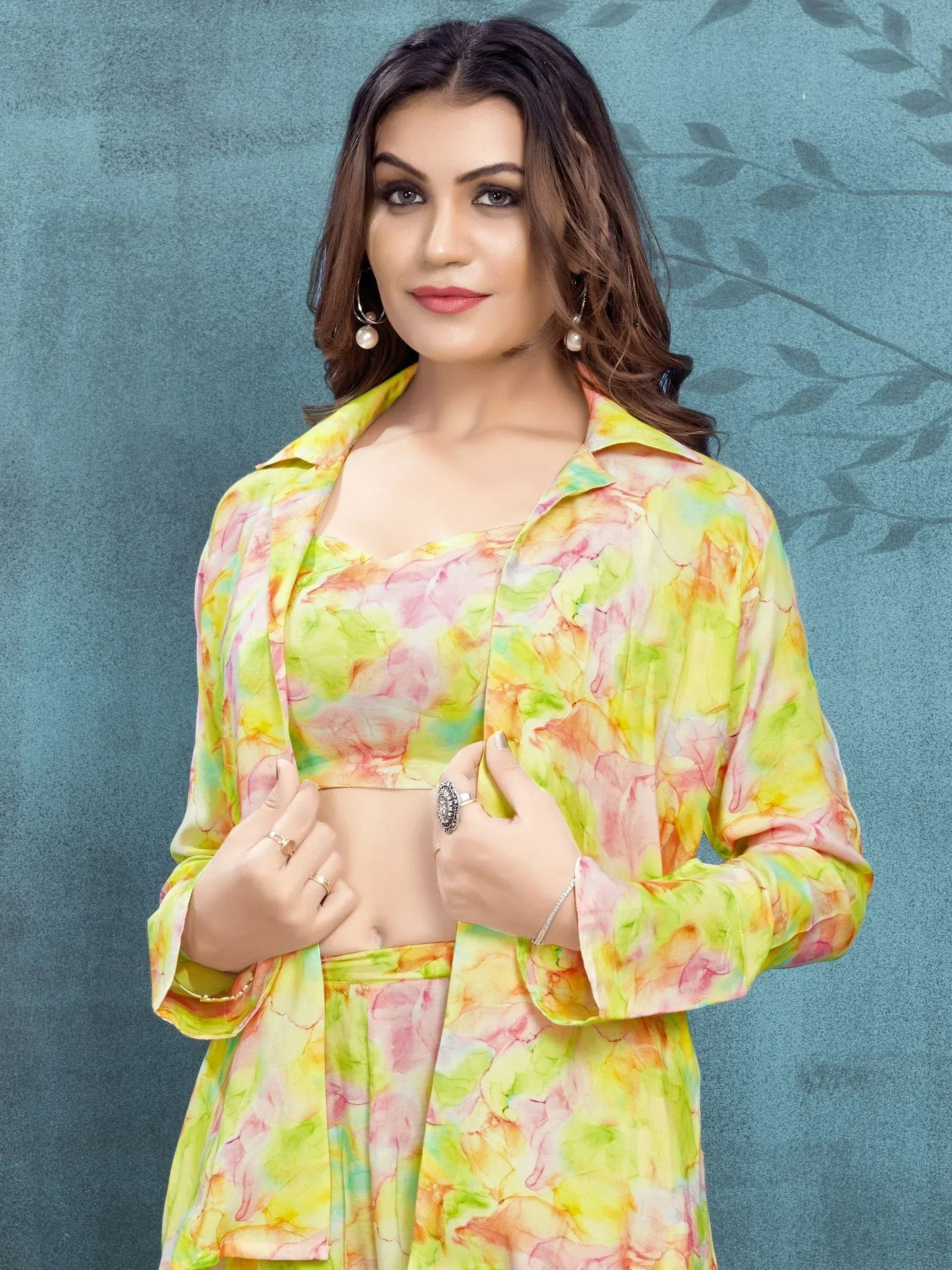Woman in vibrant tie-dye ethnic crop top and matching skirt, stylish Indian wear for festive occasions