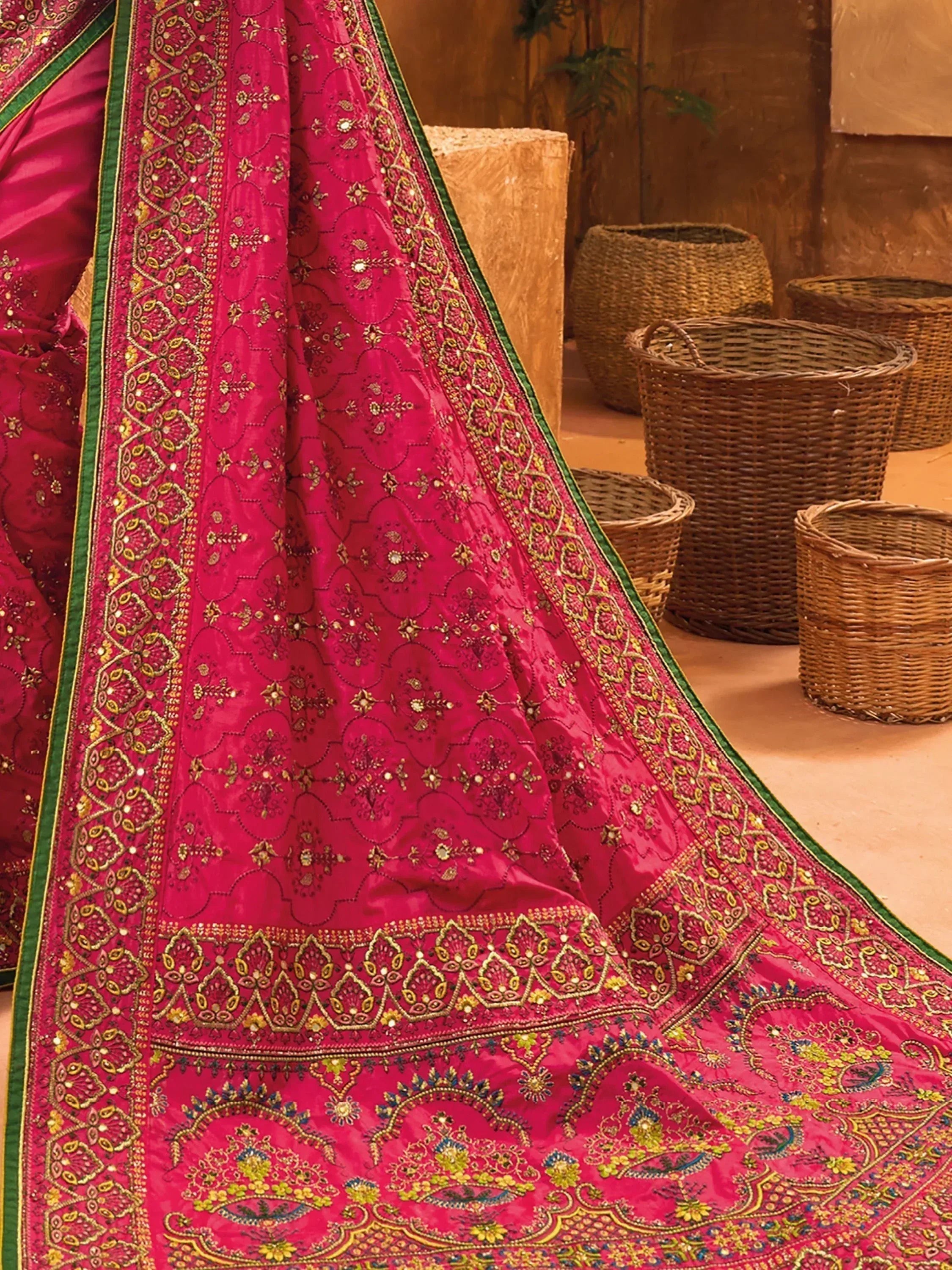 Pink embroidered lehenga choli with gold and green detailing, traditional Indian ethnic wear