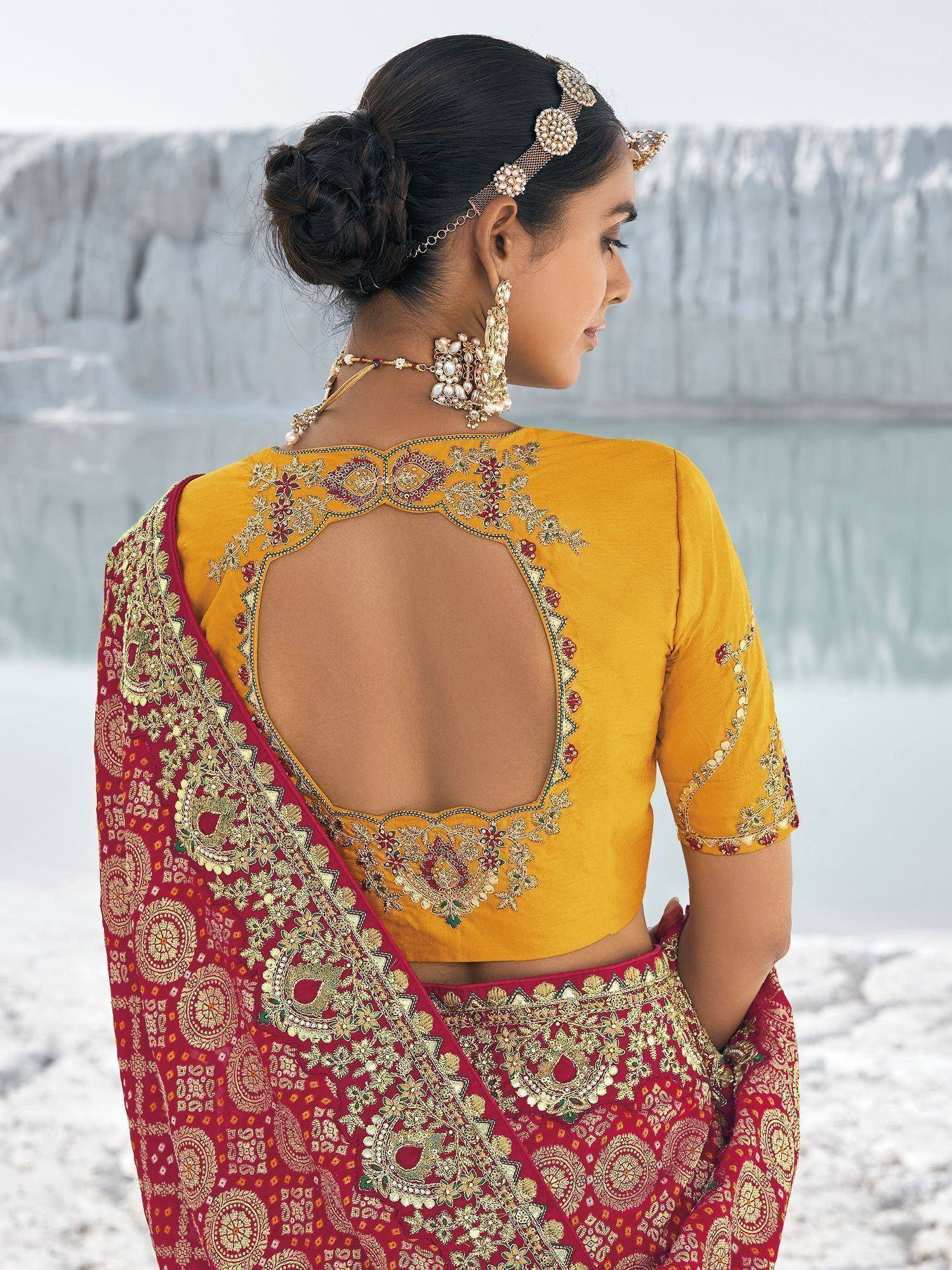 Yellow backless blouse with red embroidered lehenga, ethnic Indian wear for weddings