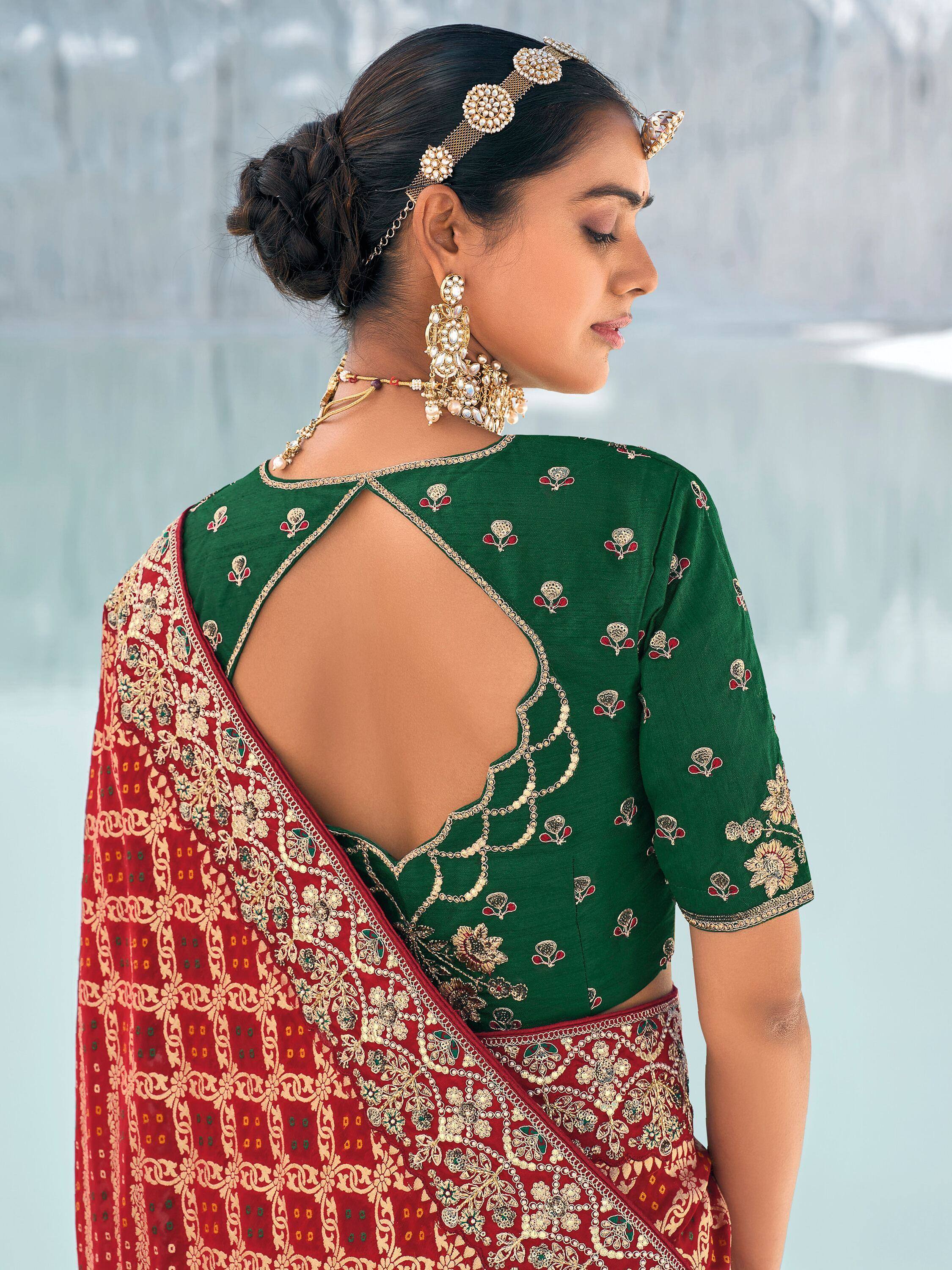 Green embroidered blouse with back cutout paired with red designer saree, traditional Indian ethnic wear