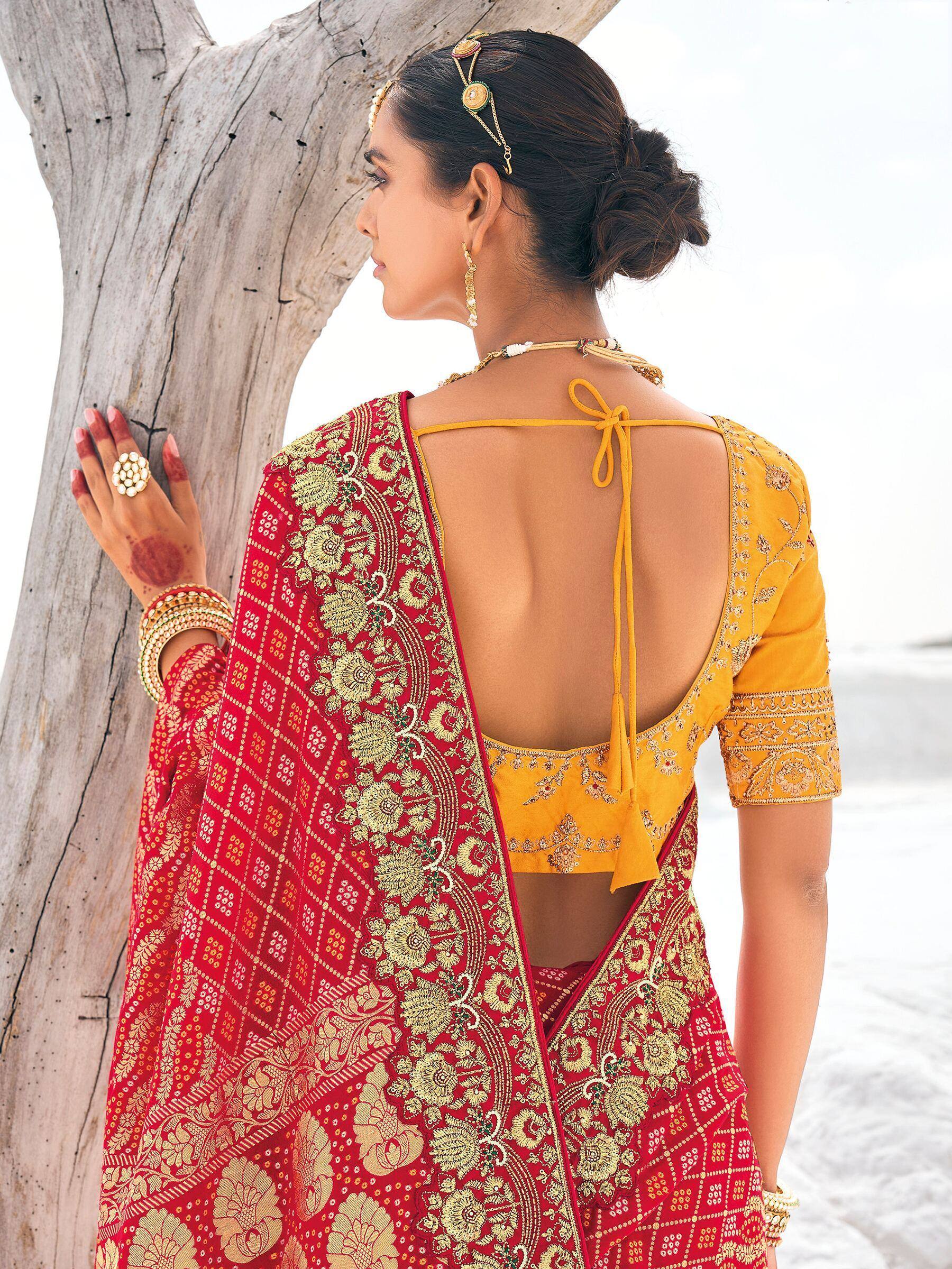 Red and gold embroidered saree with yellow backless blouse, ethnic Indian wear for weddings or festivals