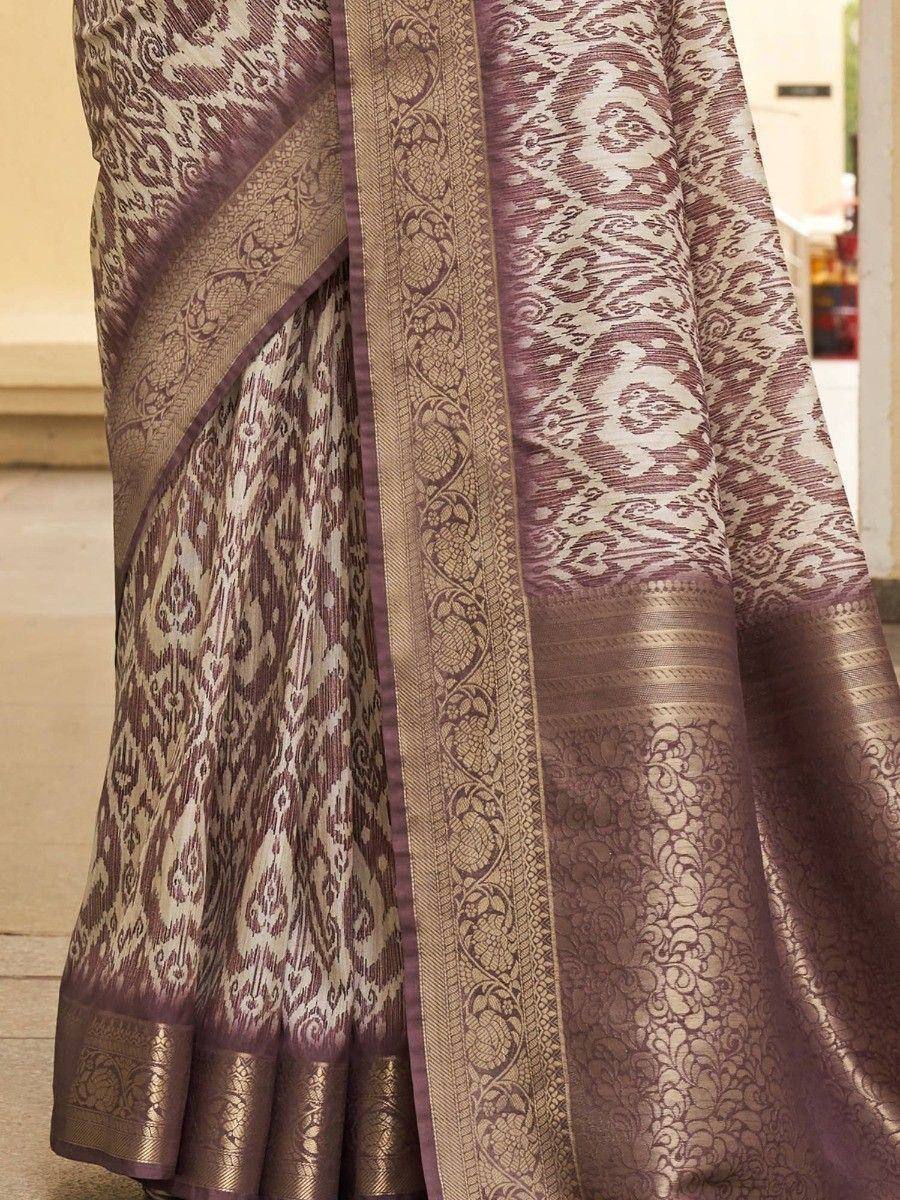 Elegant purple and gold ikat saree with intricate woven border, perfect for ethnic occasions