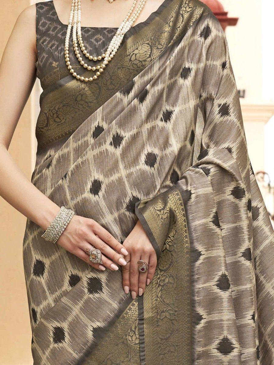 Elegant olive ikat saree with gold border, paired with pearl necklace and traditional jewelry for ethnic wear.