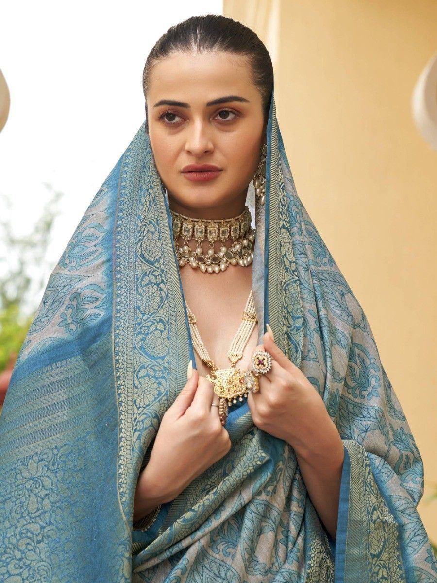 Elegant blue printed saree with gold jewelry, perfect for Indian ethnic occasions