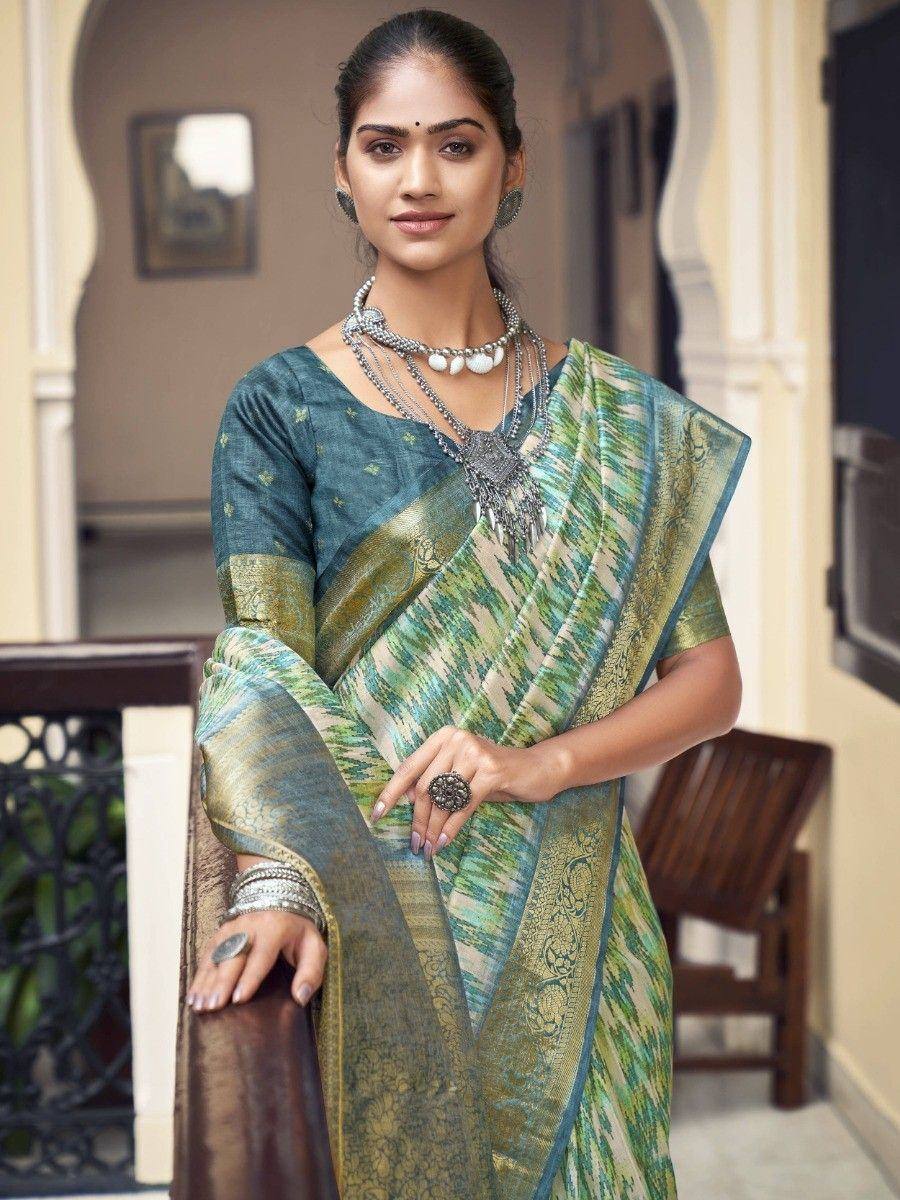 Woman in green and gold ikat saree with designer blouse, traditional Indian ethnic wear