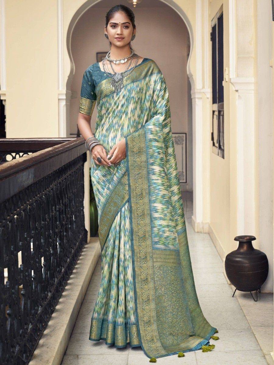 Woman in elegant green and blue ikat saree with gold border, styled for ethnic occasions