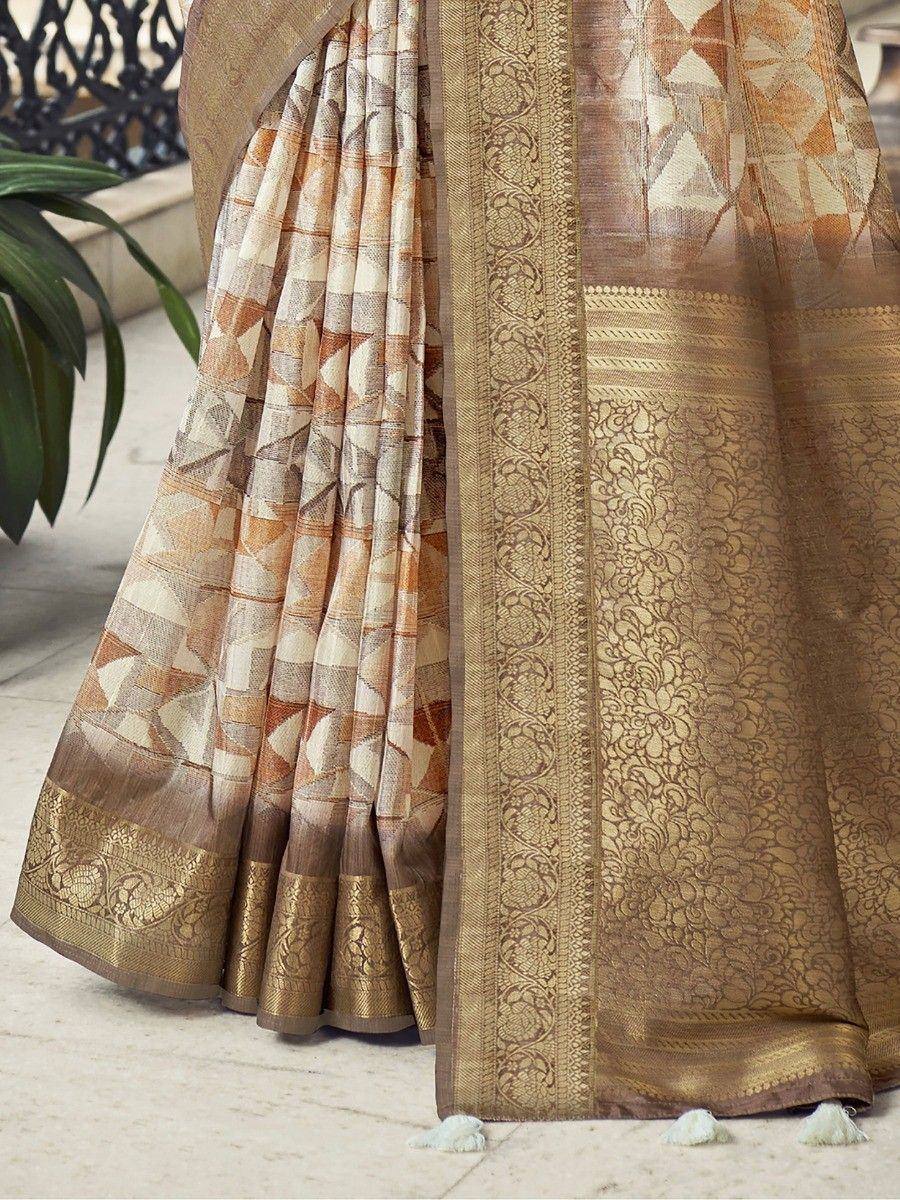 Elegant beige and gold saree with geometric print and intricate border, perfect for Indian ethnic wear