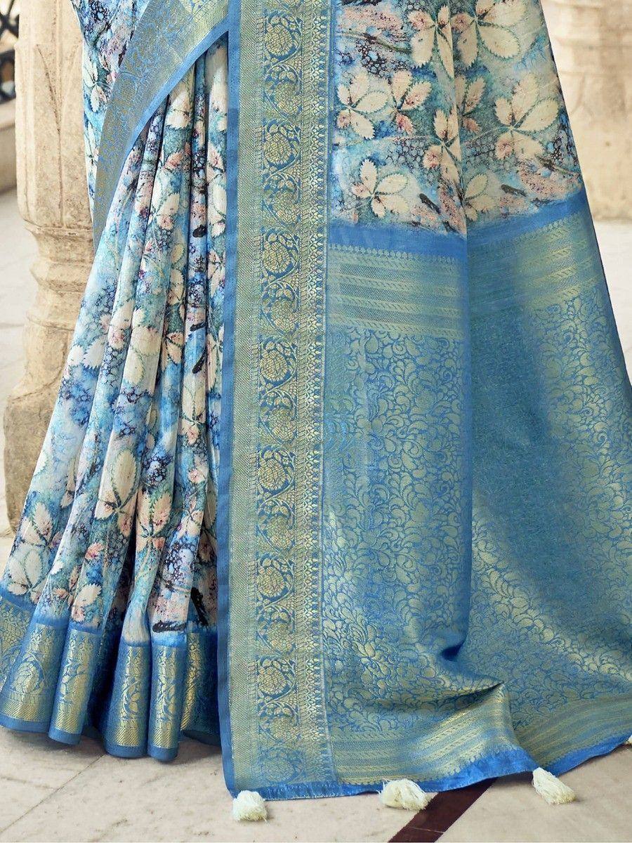 Blue floral print saree with gold zari border and tassels, ethnic Indian wear