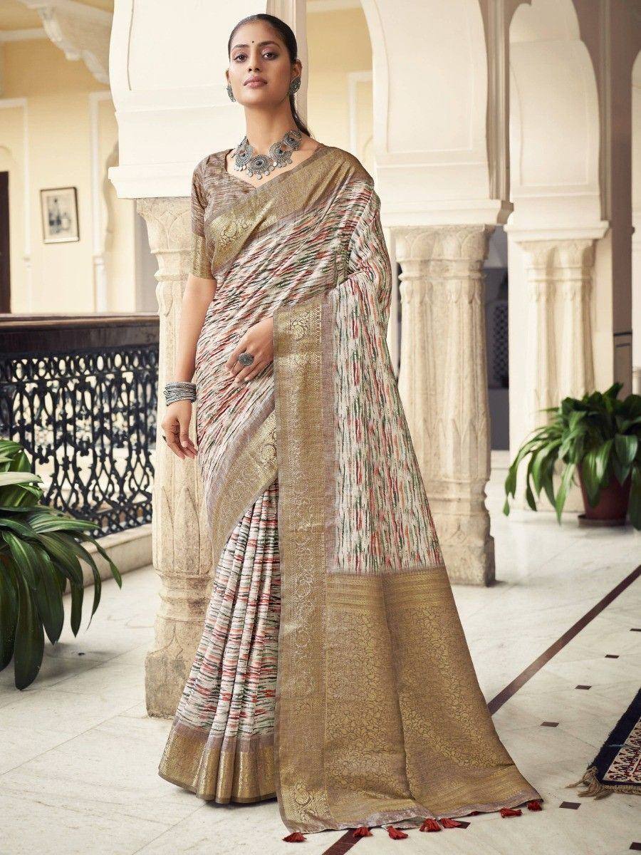 Woman in elegant Indian saree with gold border and colorful stripes, styled with traditional jewelry