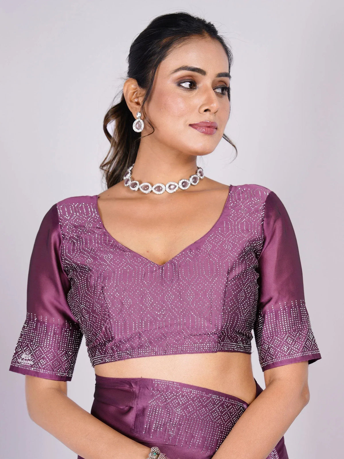 Purple designer saree blouse with sequin work and V-neck, paired with matching skirt for ethnic wear