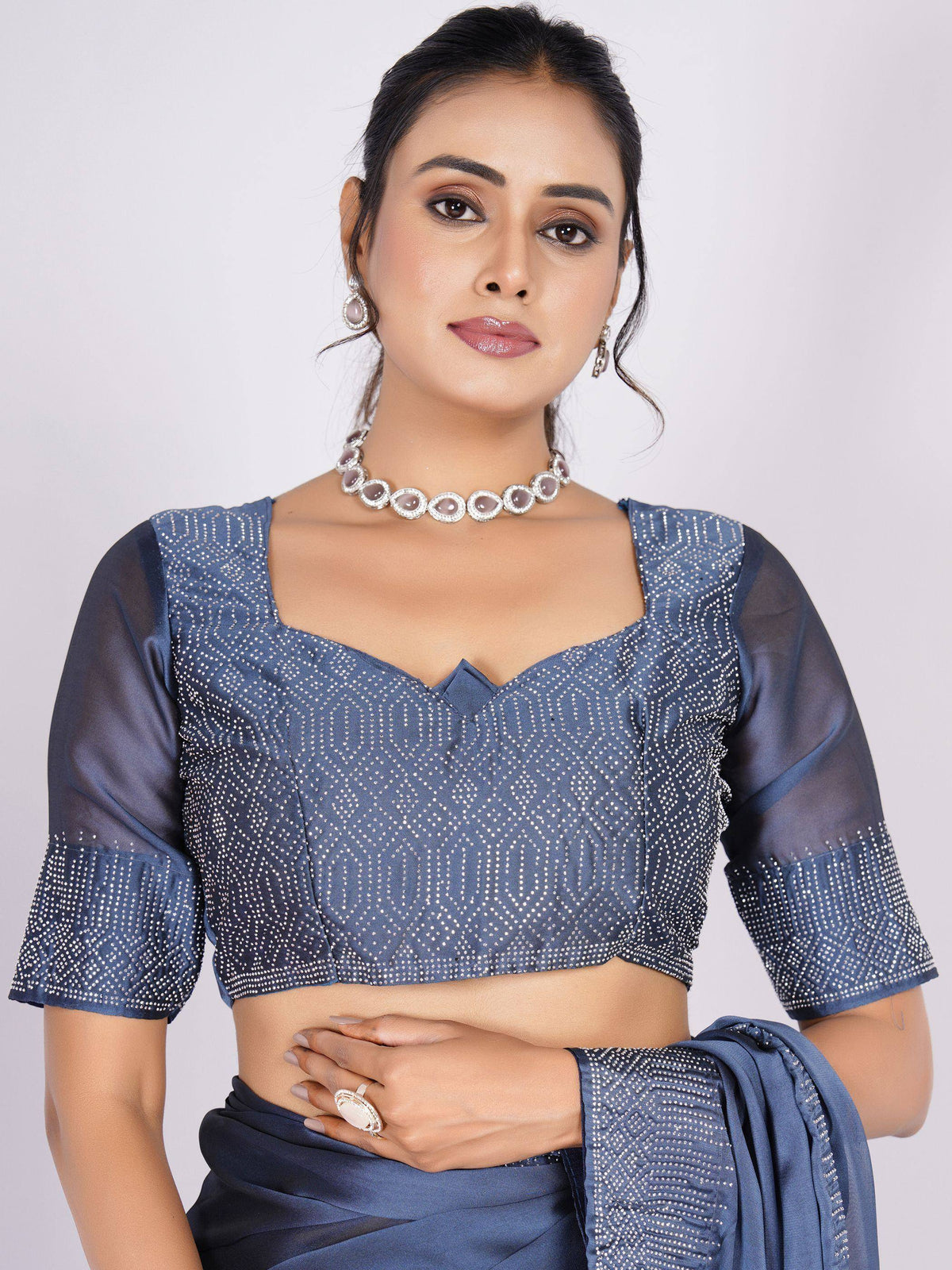 Blue embellished saree blouse with sheer sleeves and statement jewelry for ethnic wear