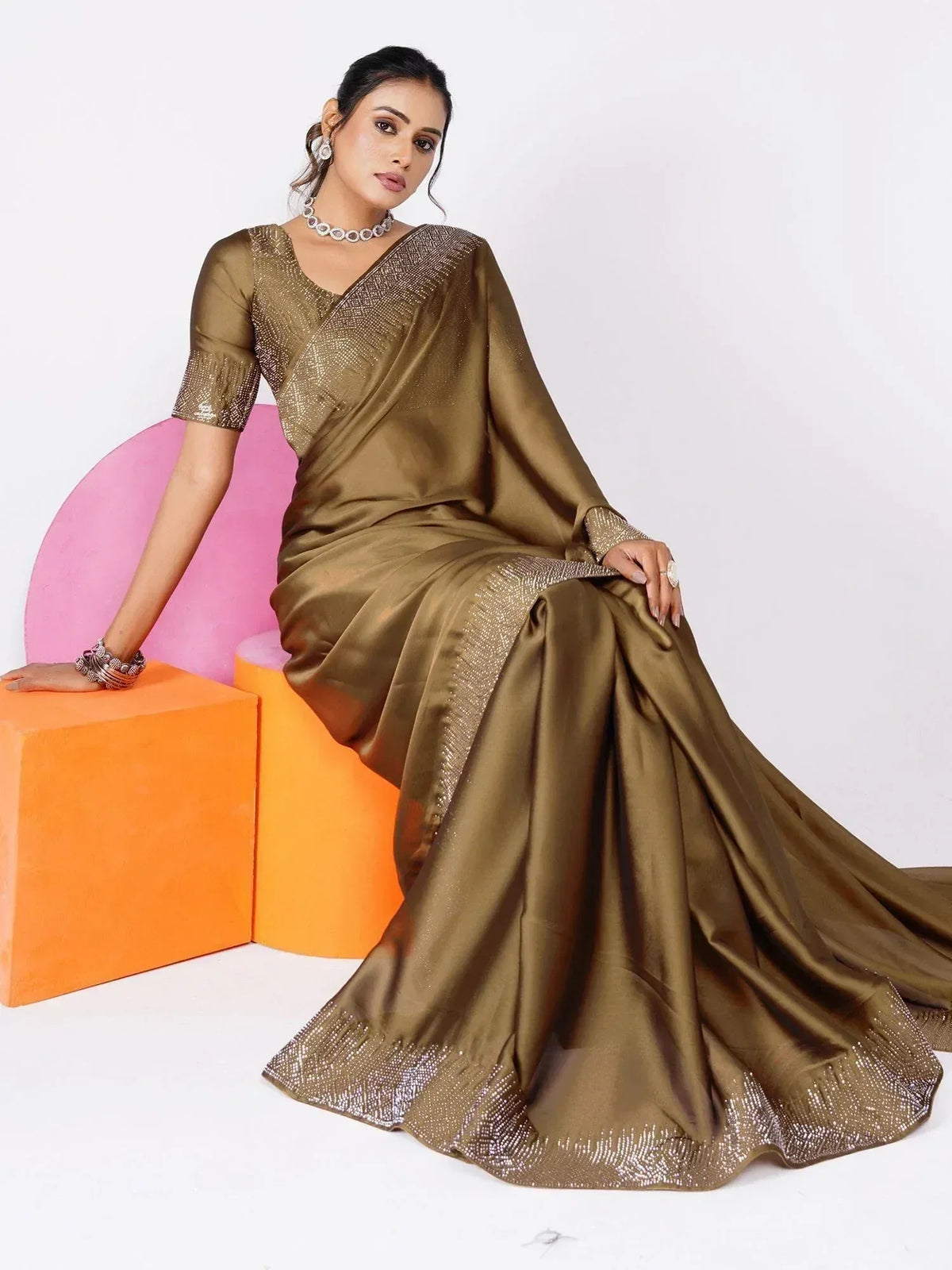 Elegant olive green saree with sequin border and blouse, styled for Indian ethnic wear occasions.