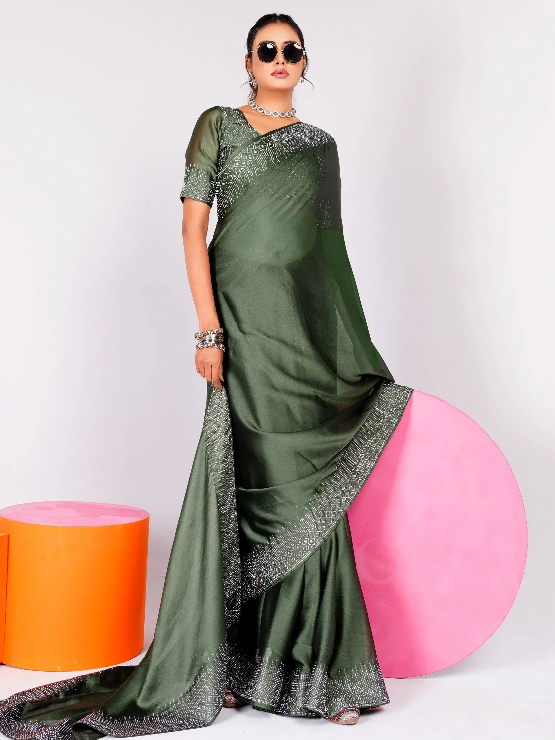 Olive green designer saree with sequin border, styled with sunglasses and ethnic jewelry for modern Indian wear