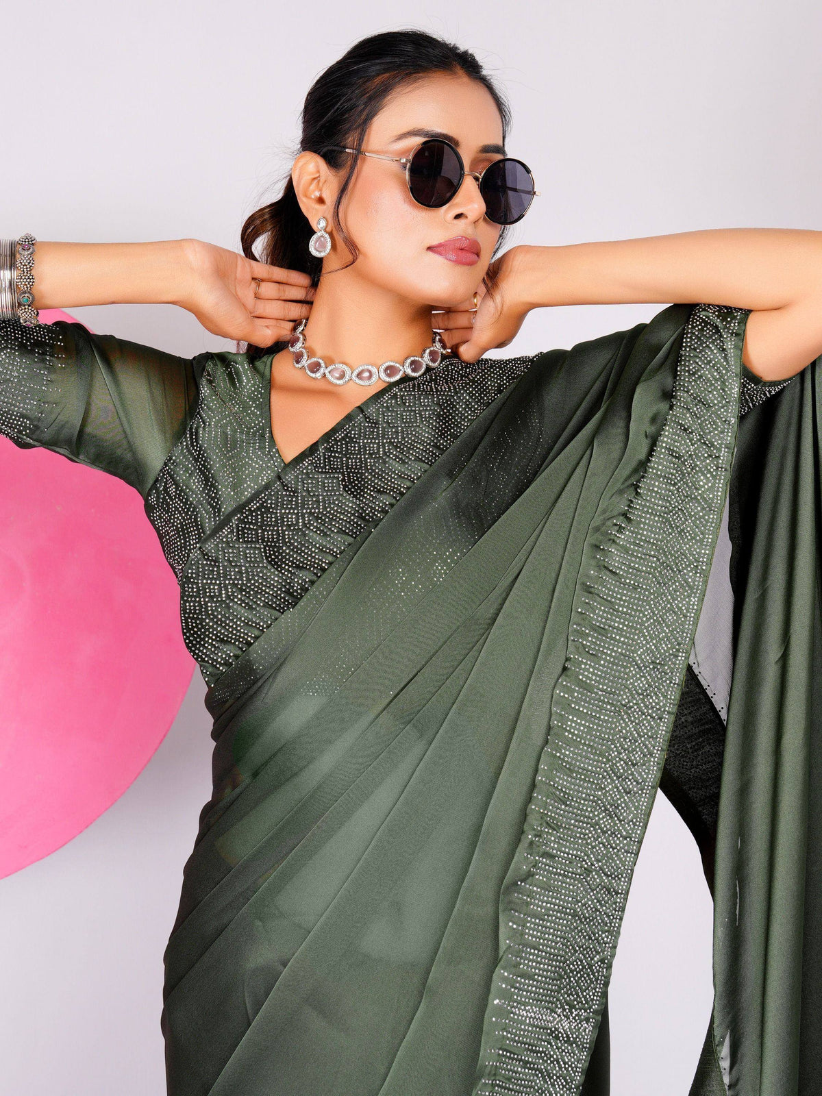 Olive green saree with sequin blouse, styled with sunglasses and jewelry for ethnic wear