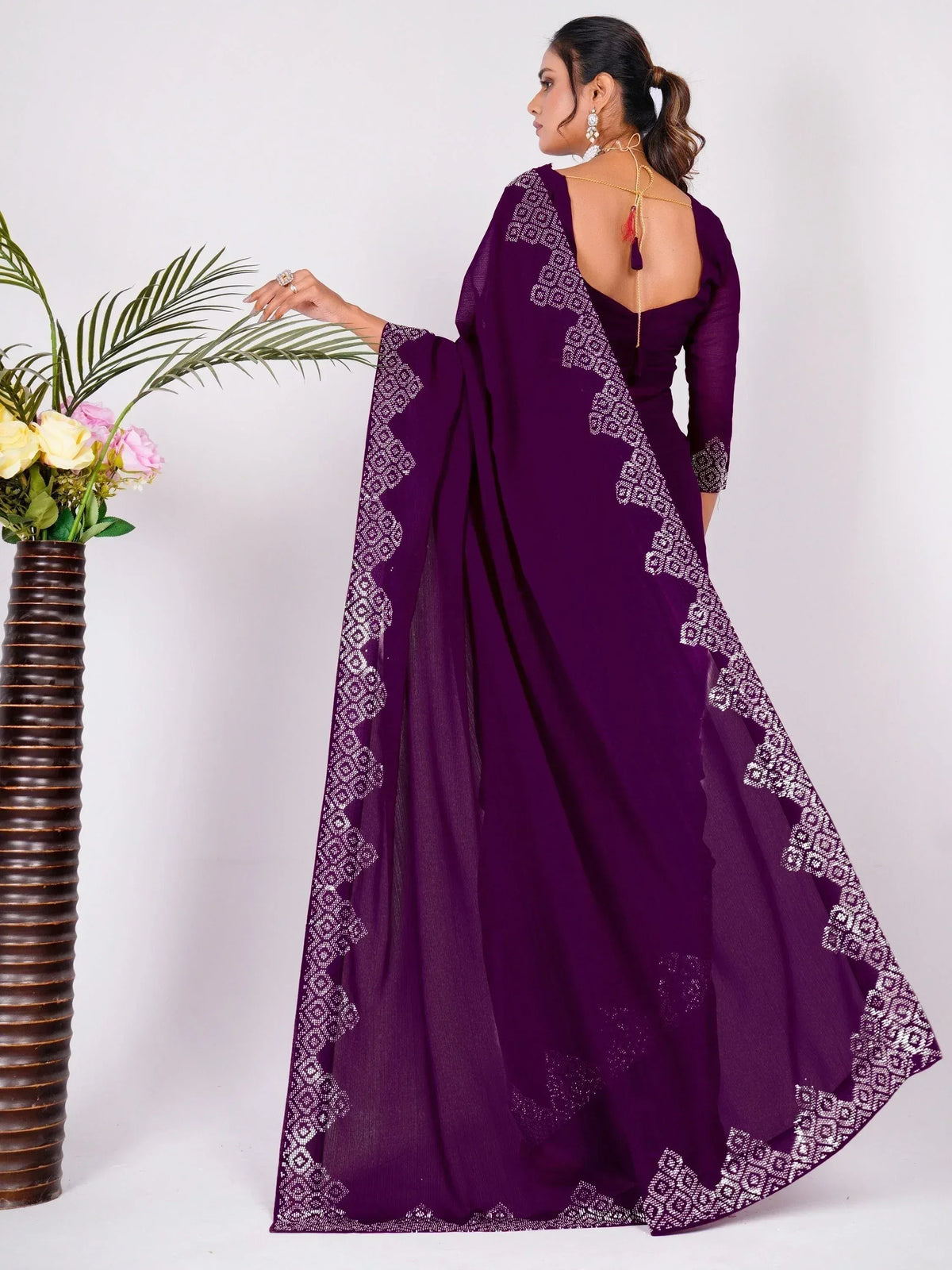 Purple ethnic gown with white geometric embroidery, backless design, and sheer dupatta for Indian occasions
