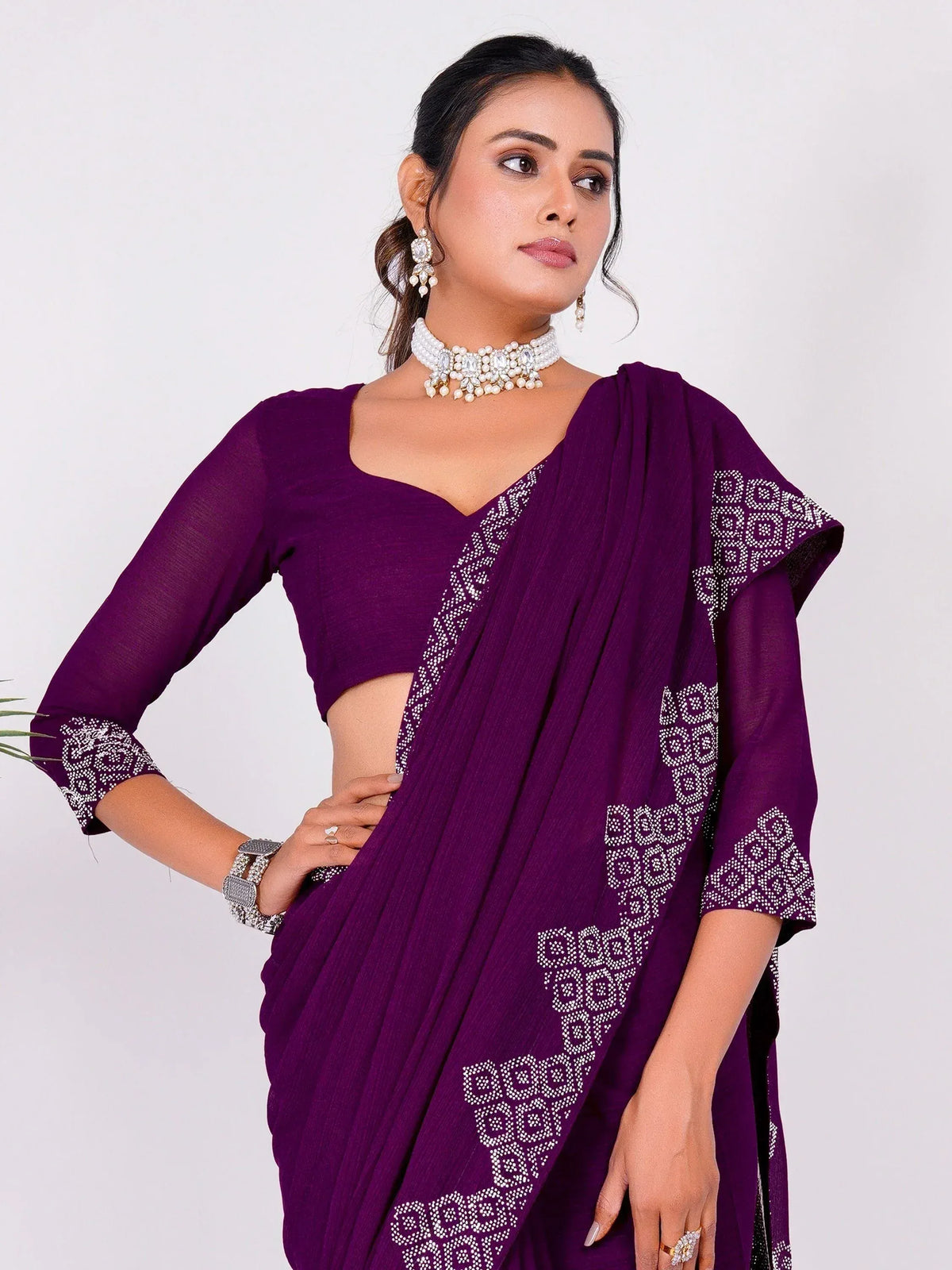 Purple ethnic saree with white embroidery, paired with matching blouse and pearl jewelry for festive occasions