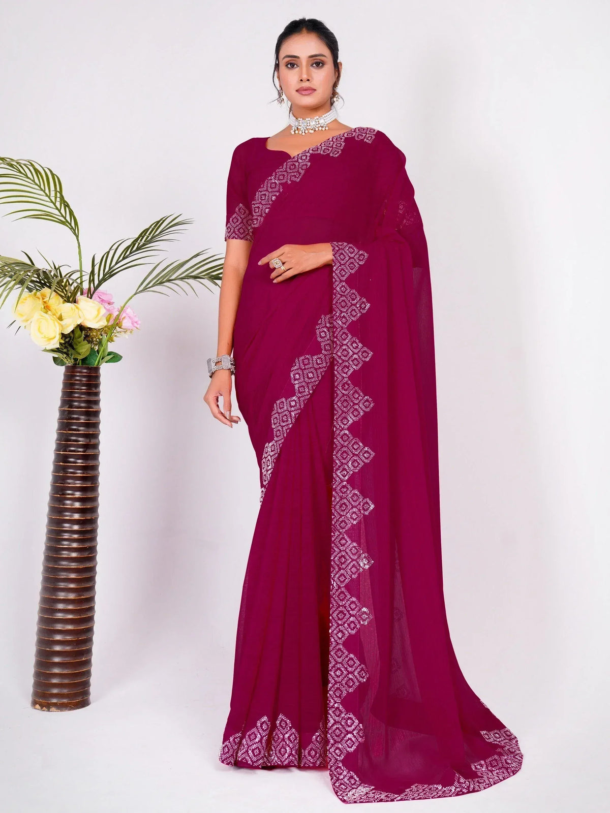Elegant maroon saree with white geometric embroidery, perfect for Indian ethnic occasions and events.