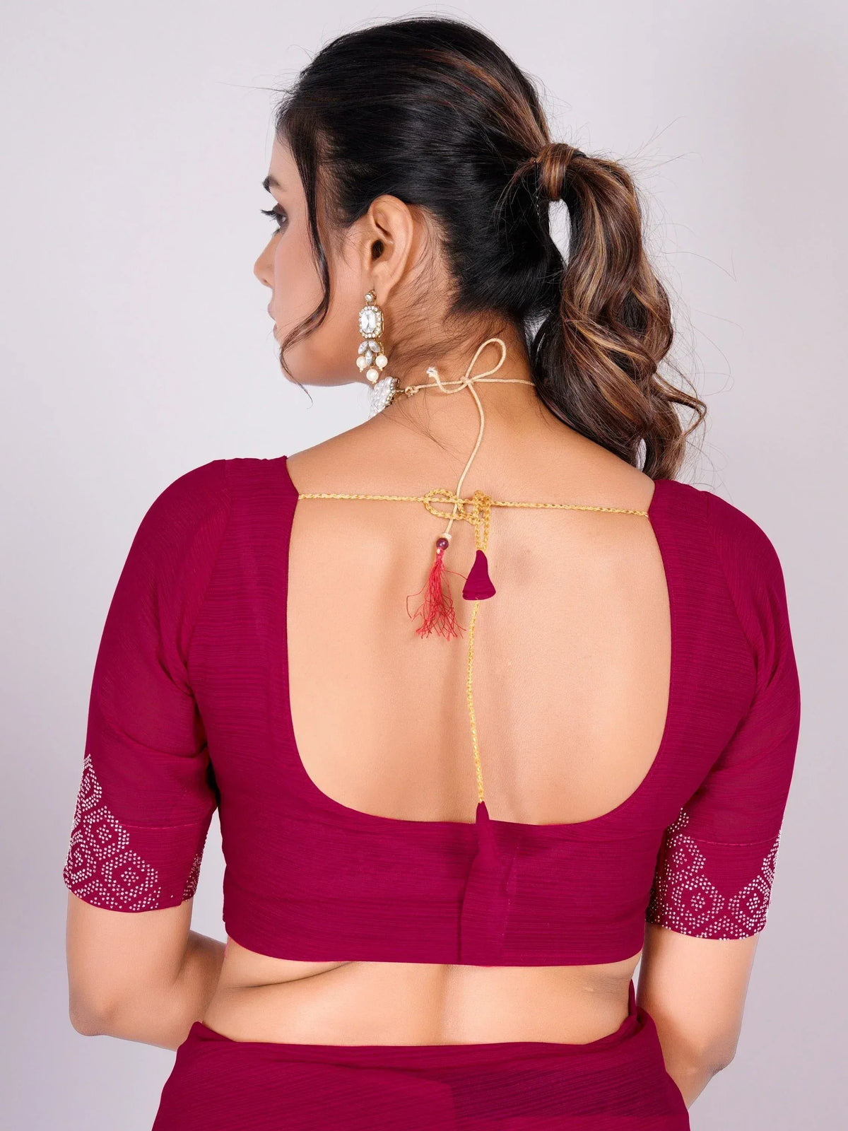 Maroon saree blouse with open back, tassels, and embroidered sleeves for Indian ethnic wear