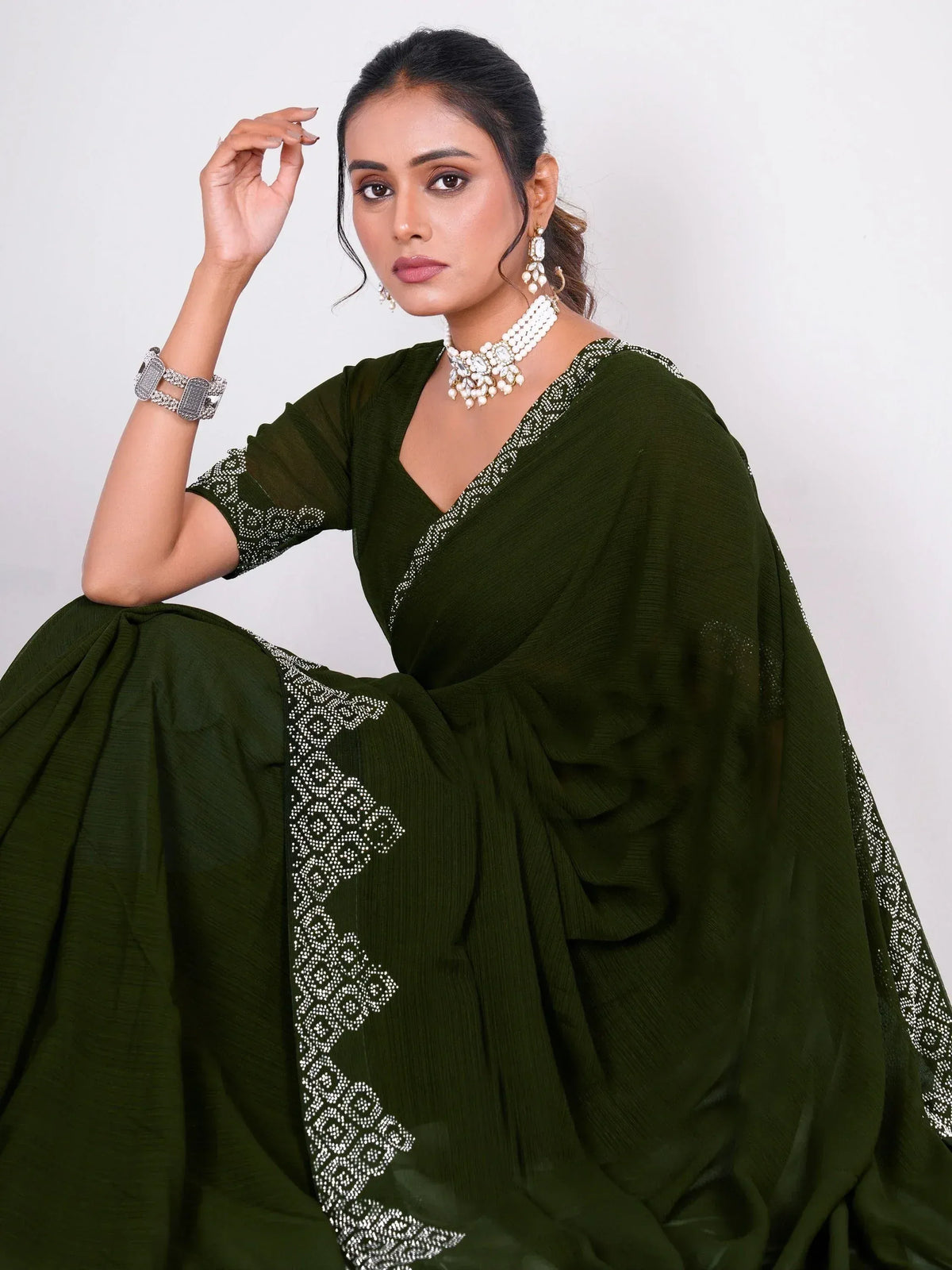 Olive green ethnic gown with white embroidery, paired with pearl jewelry for Indian wear