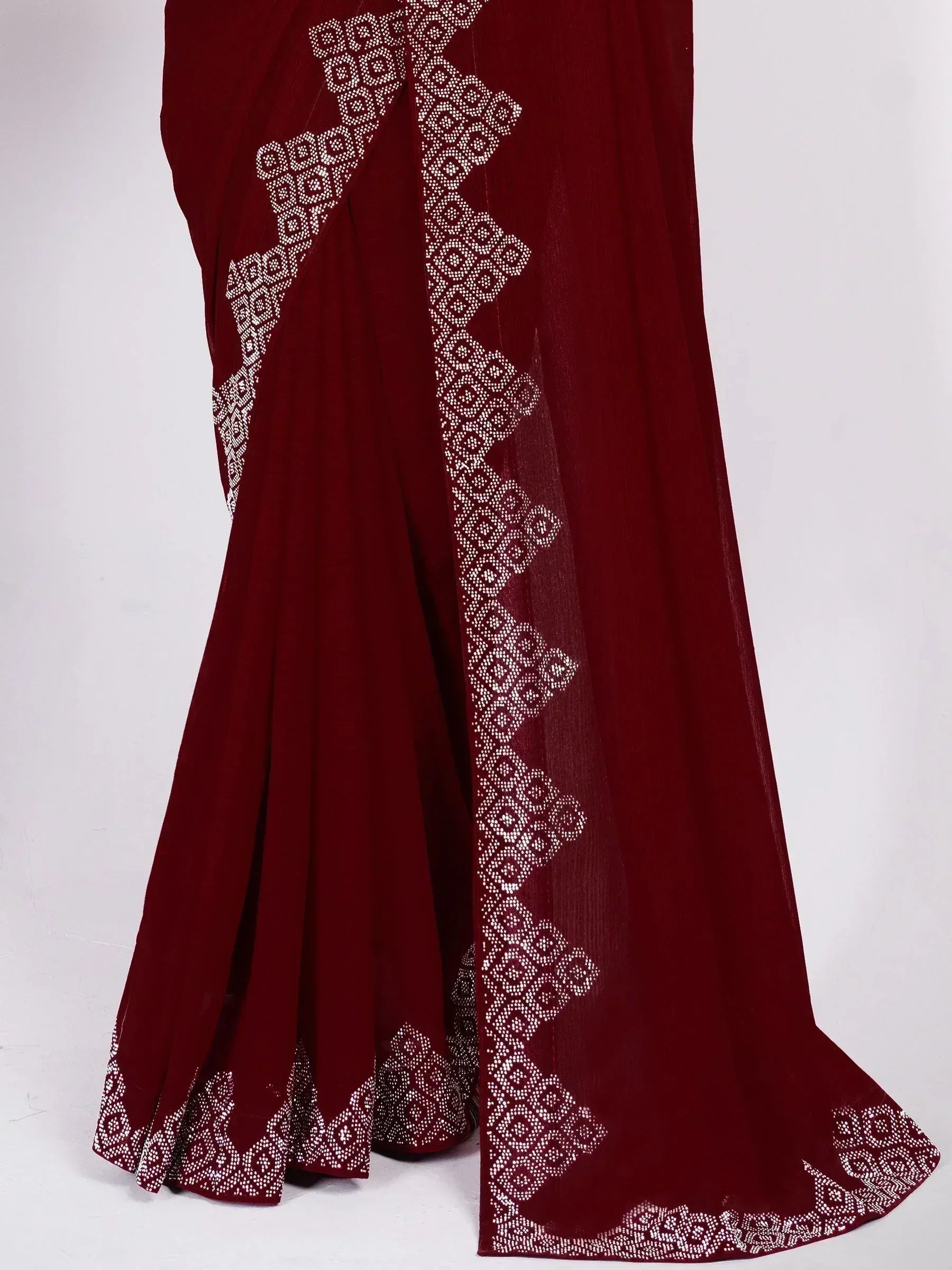 Maroon ethnic saree with white geometric embroidery, perfect for Indian festive occasions