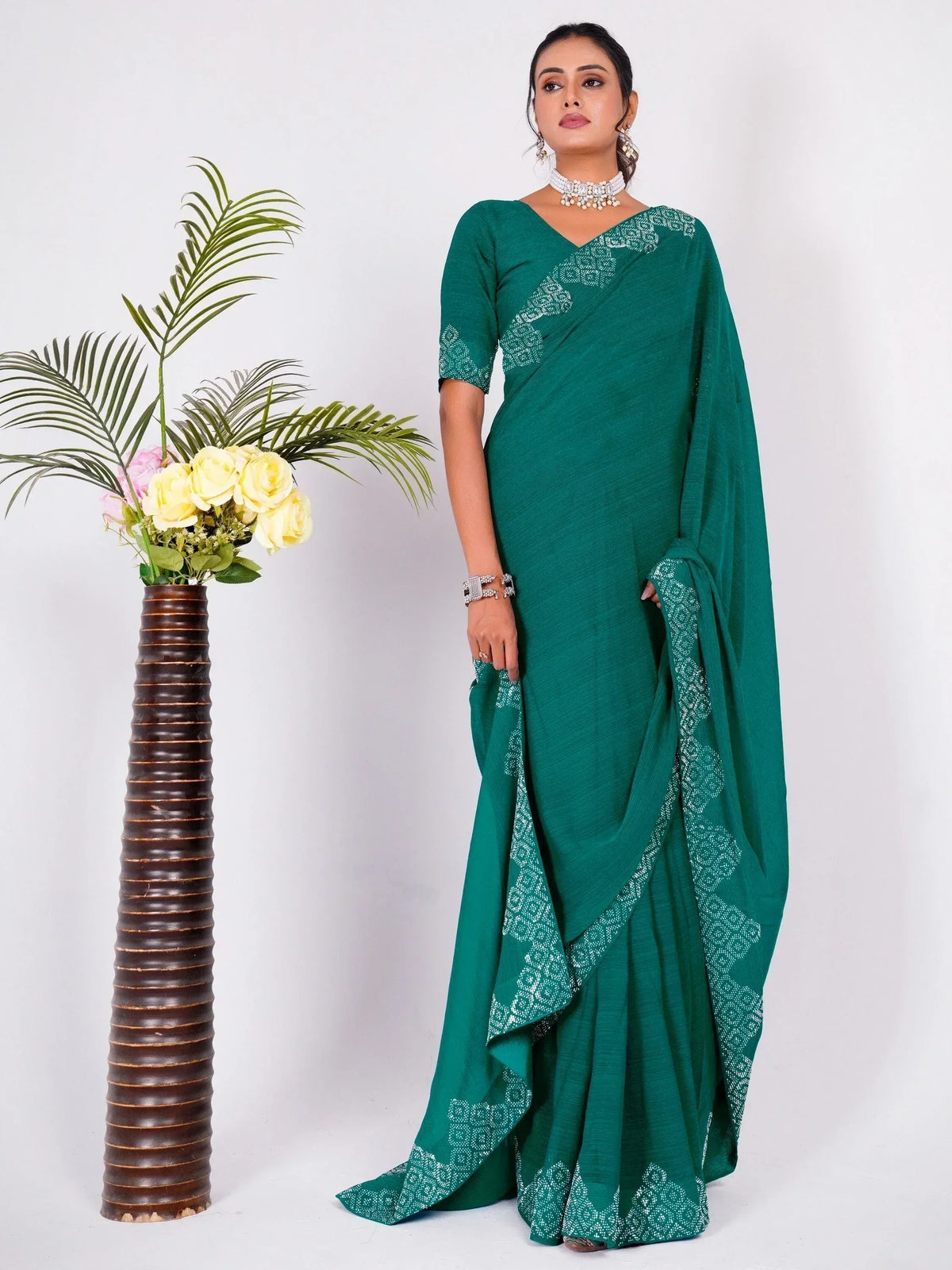 Emerald green saree with white embroidery, styled with jewelry, perfect for Indian ethnic occasions.