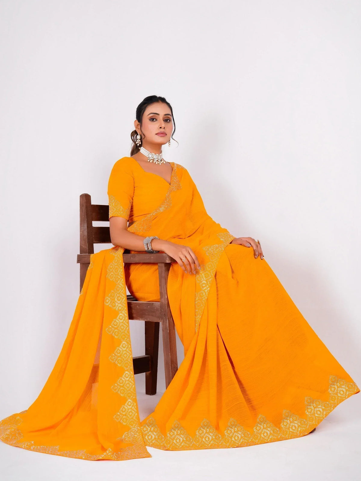 Vibrant yellow saree with gold embroidery, styled with matching blouse and traditional jewelry for ethnic occasions