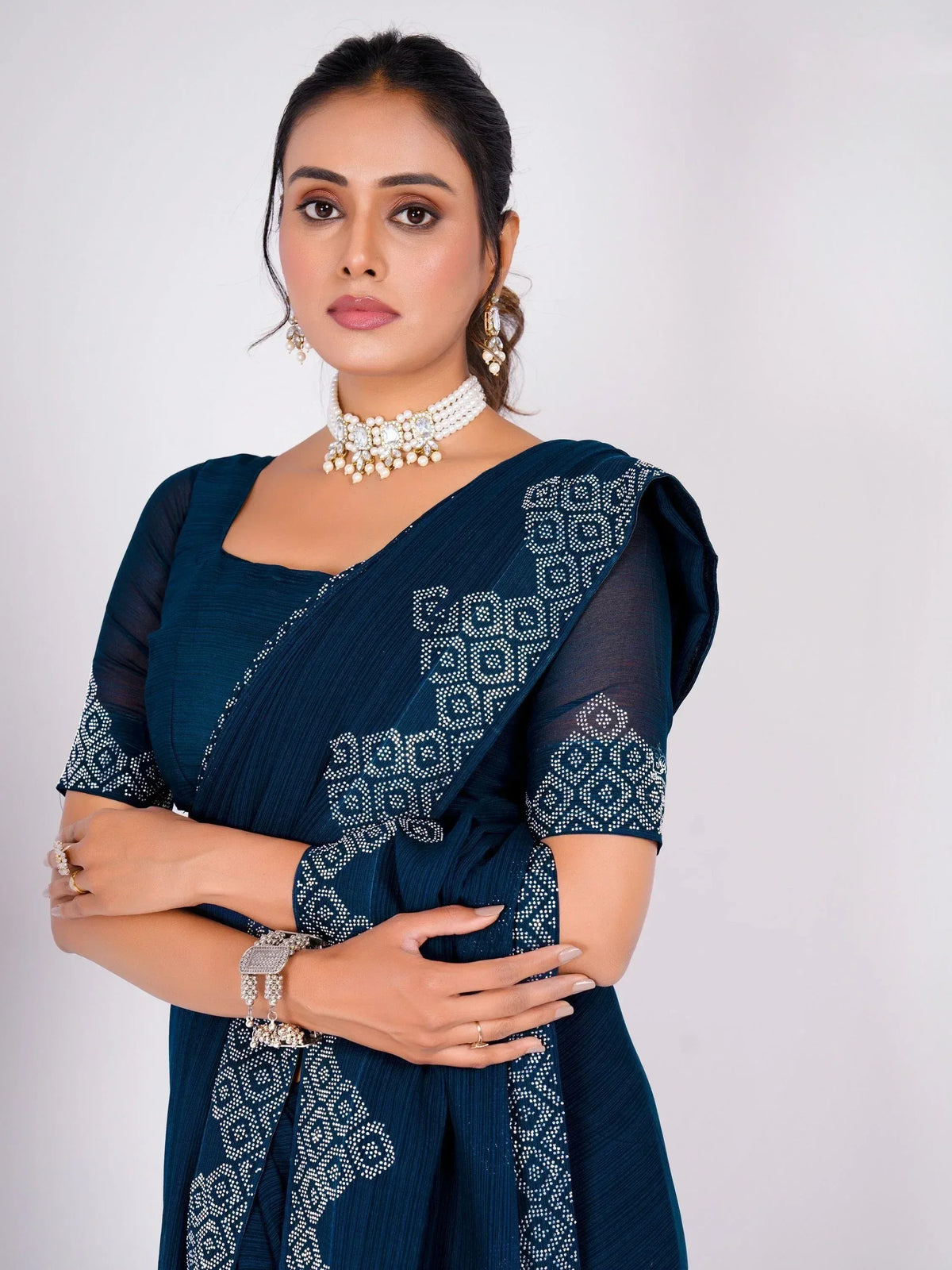 Elegant navy blue saree with white embroidery, paired with pearl jewelry for Indian ethnic wear
