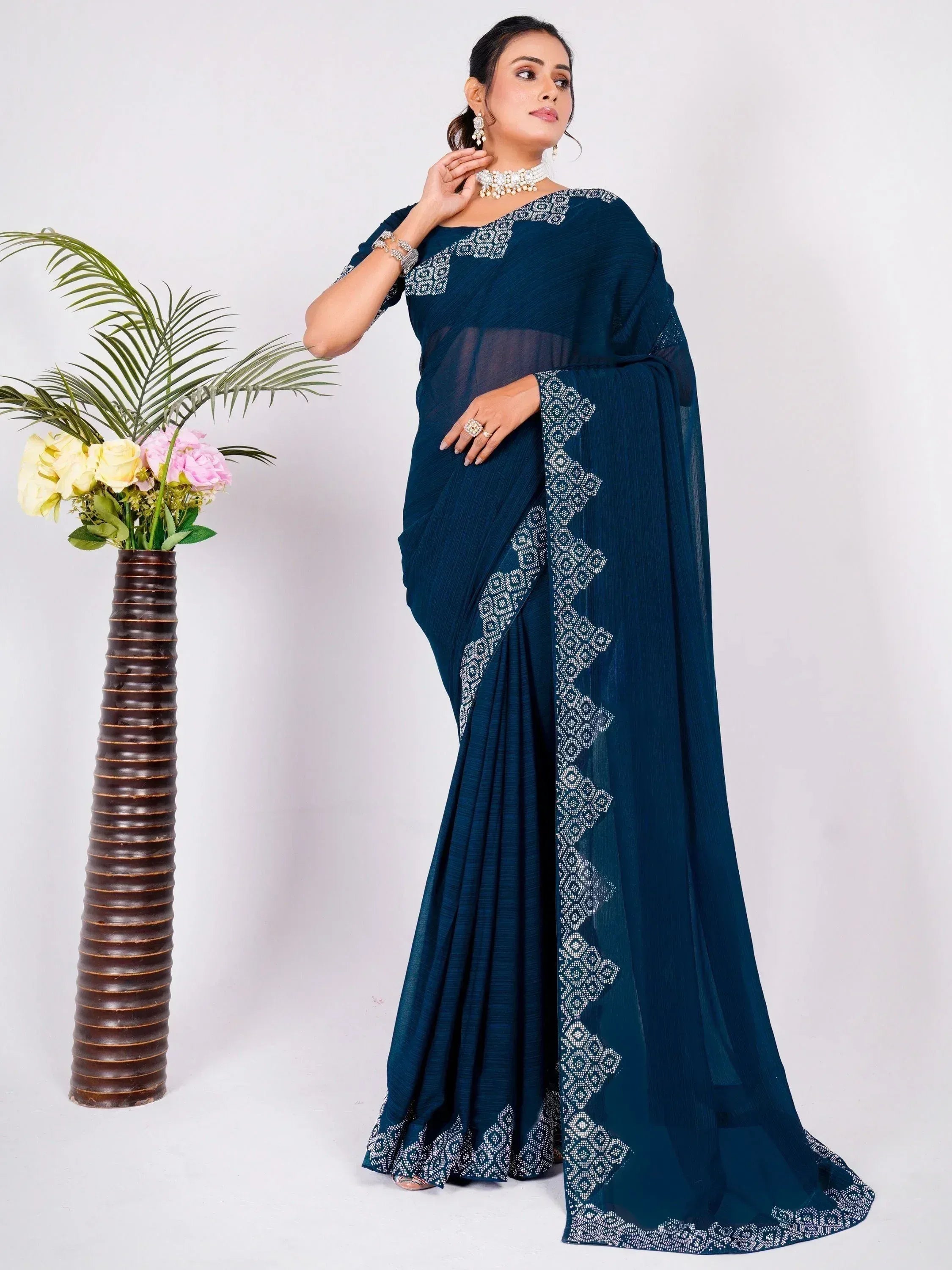 Elegant navy blue saree with white geometric embroidery, perfect for Indian ethnic wear occasions.