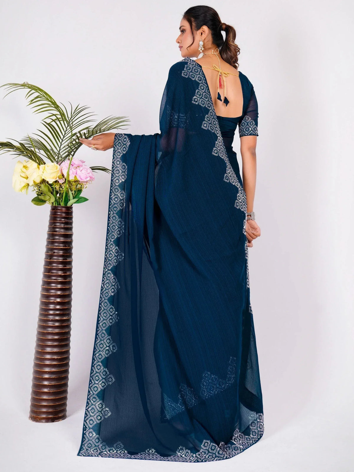 Navy blue saree with white geometric embroidery, backless blouse, and sheer pallu for ethnic wear