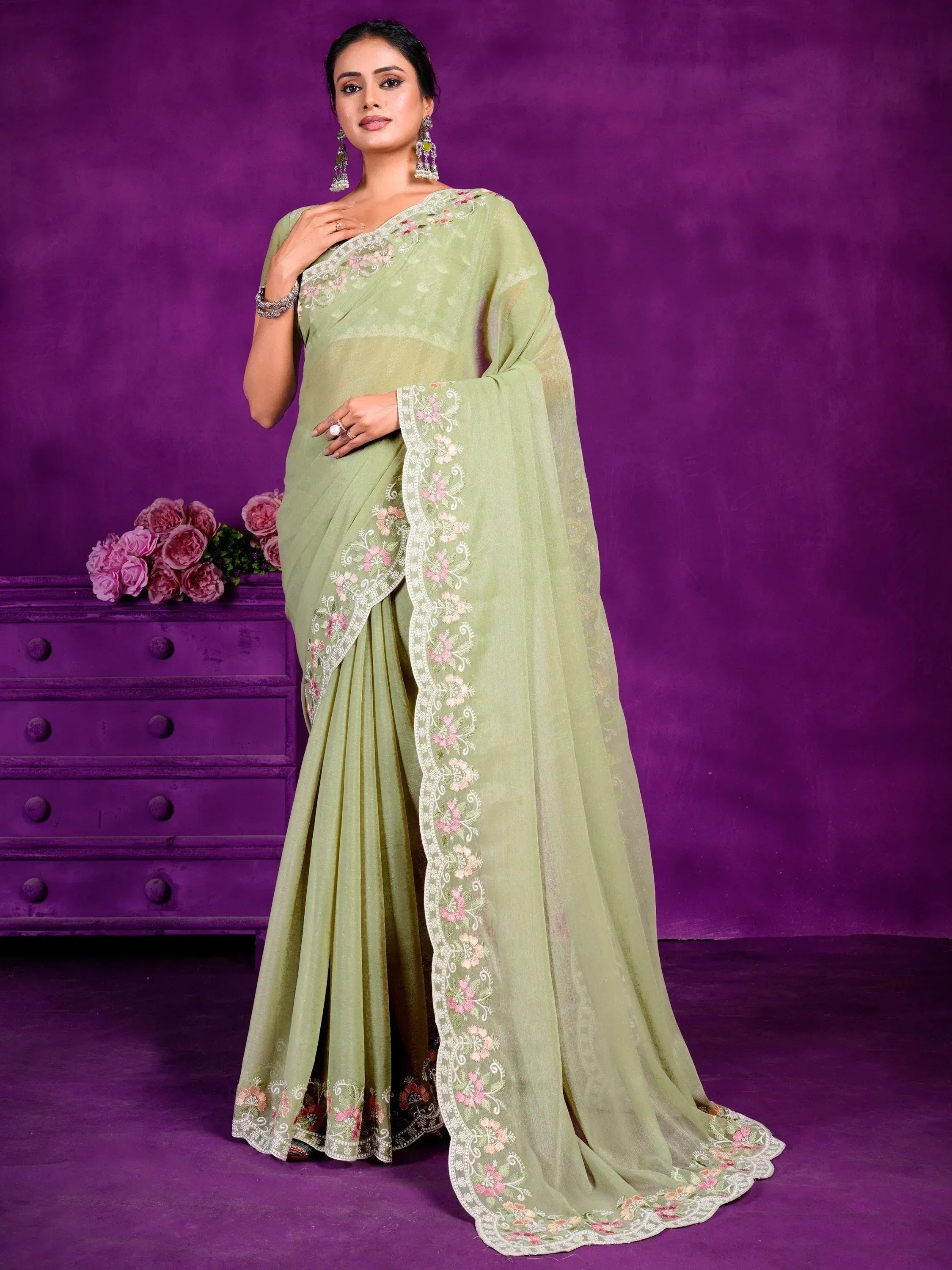 Light green embroidered saree with floral border, styled for Indian ethnic wear occasions