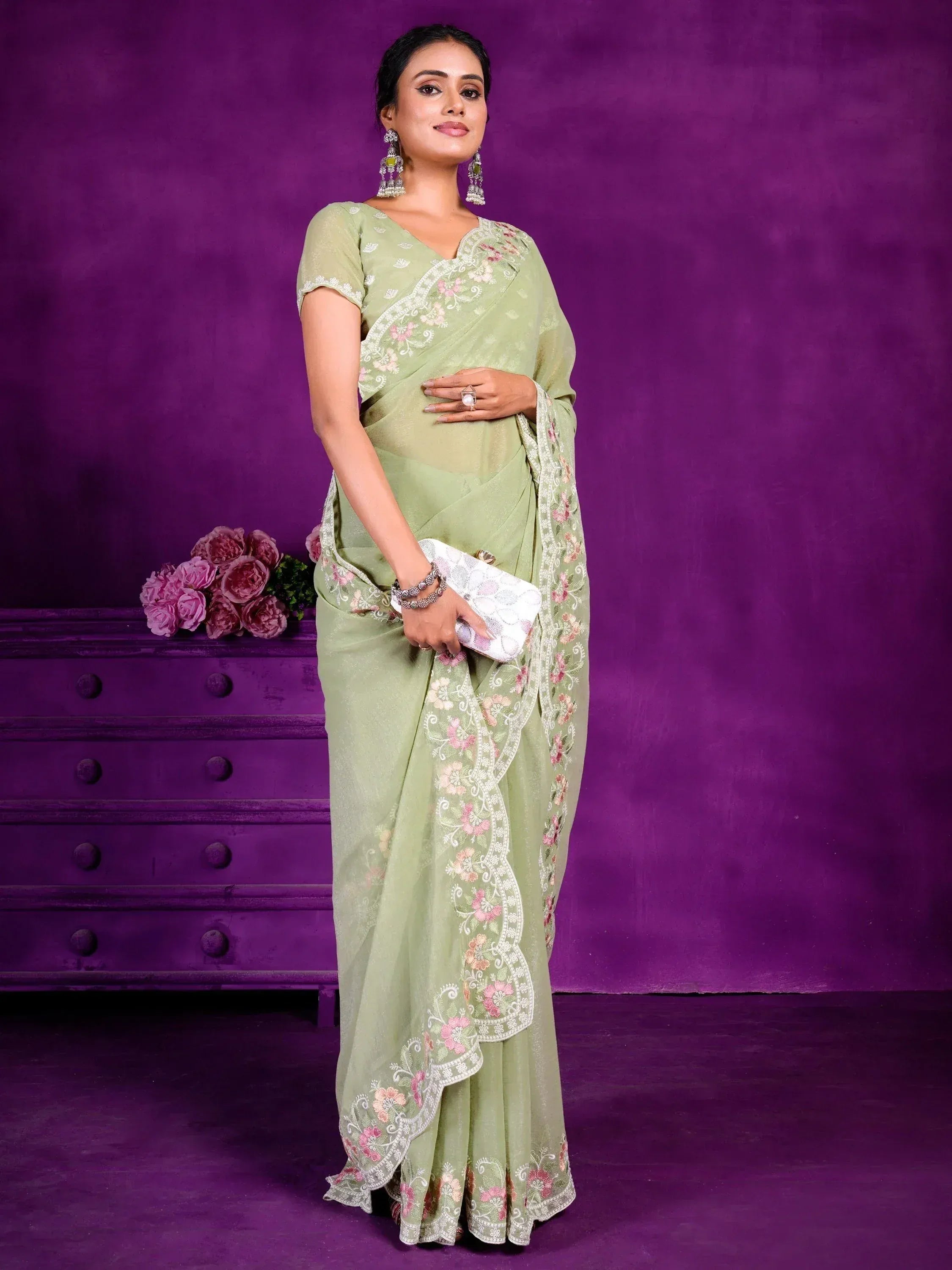 Woman in light green floral embroidered saree with matching blouse, perfect for Indian ethnic occasions