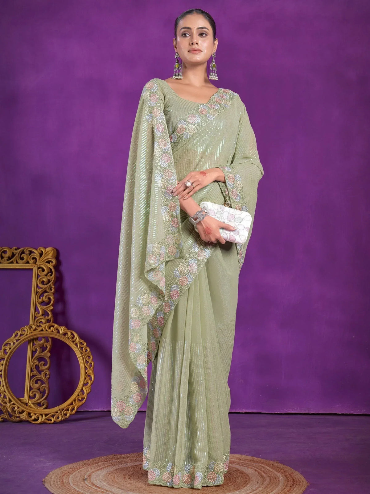 Woman in olive green sequin saree with floral embroidery, perfect for Indian ethnic wear occasions.