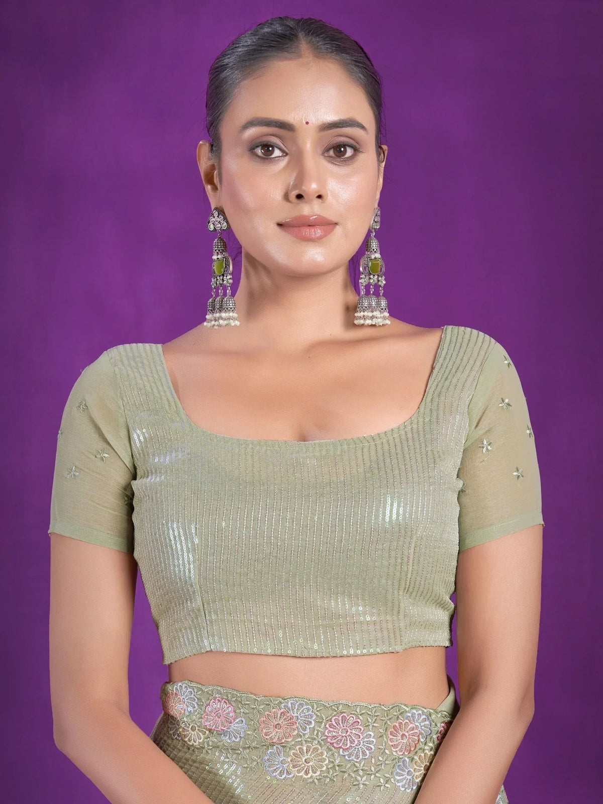 Olive green sequin lehenga choli with floral embroidery and jhumka earrings