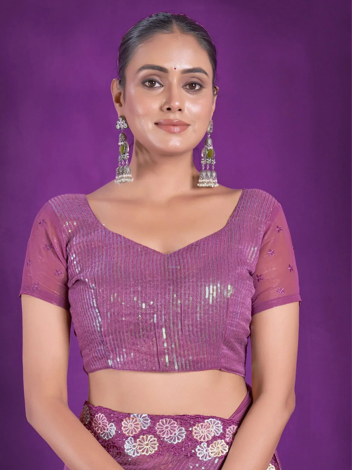 Purple sequin lehenga choli top with floral embroidery, styled with jhumka earrings for Indian ethnic wear