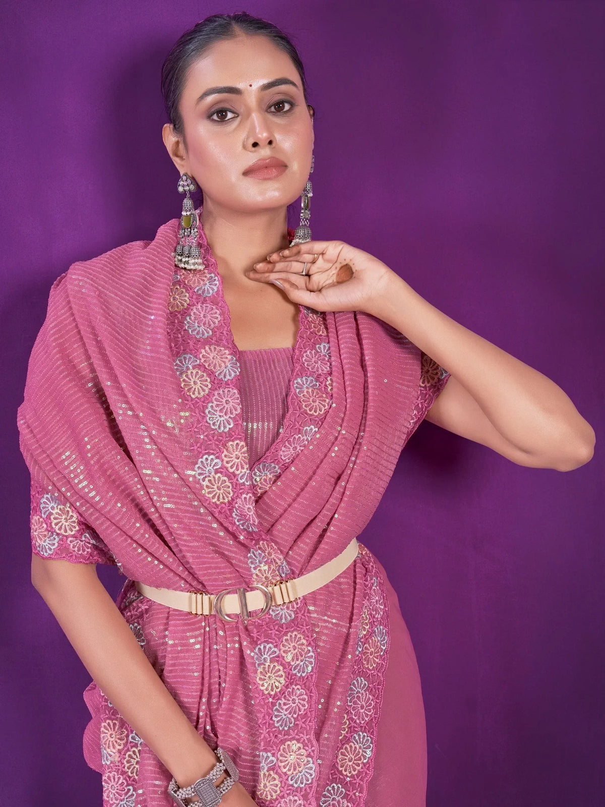 Pink floral embroidered ethnic gown with belt, styled with jhumka earrings for Indian occasions