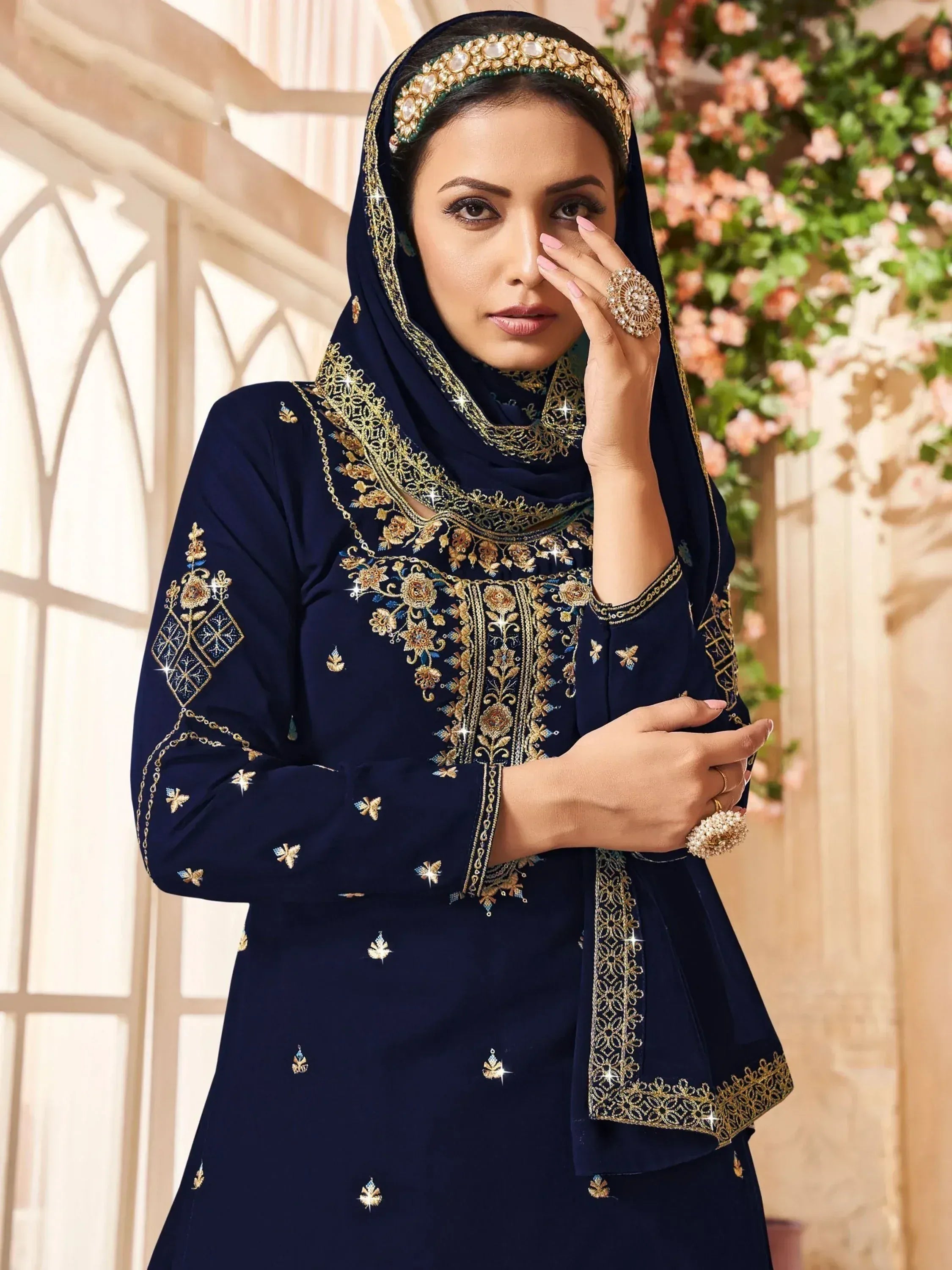 Navy blue embroidered salwar kameez with gold detailing, perfect for ethnic occasions and festive wear.