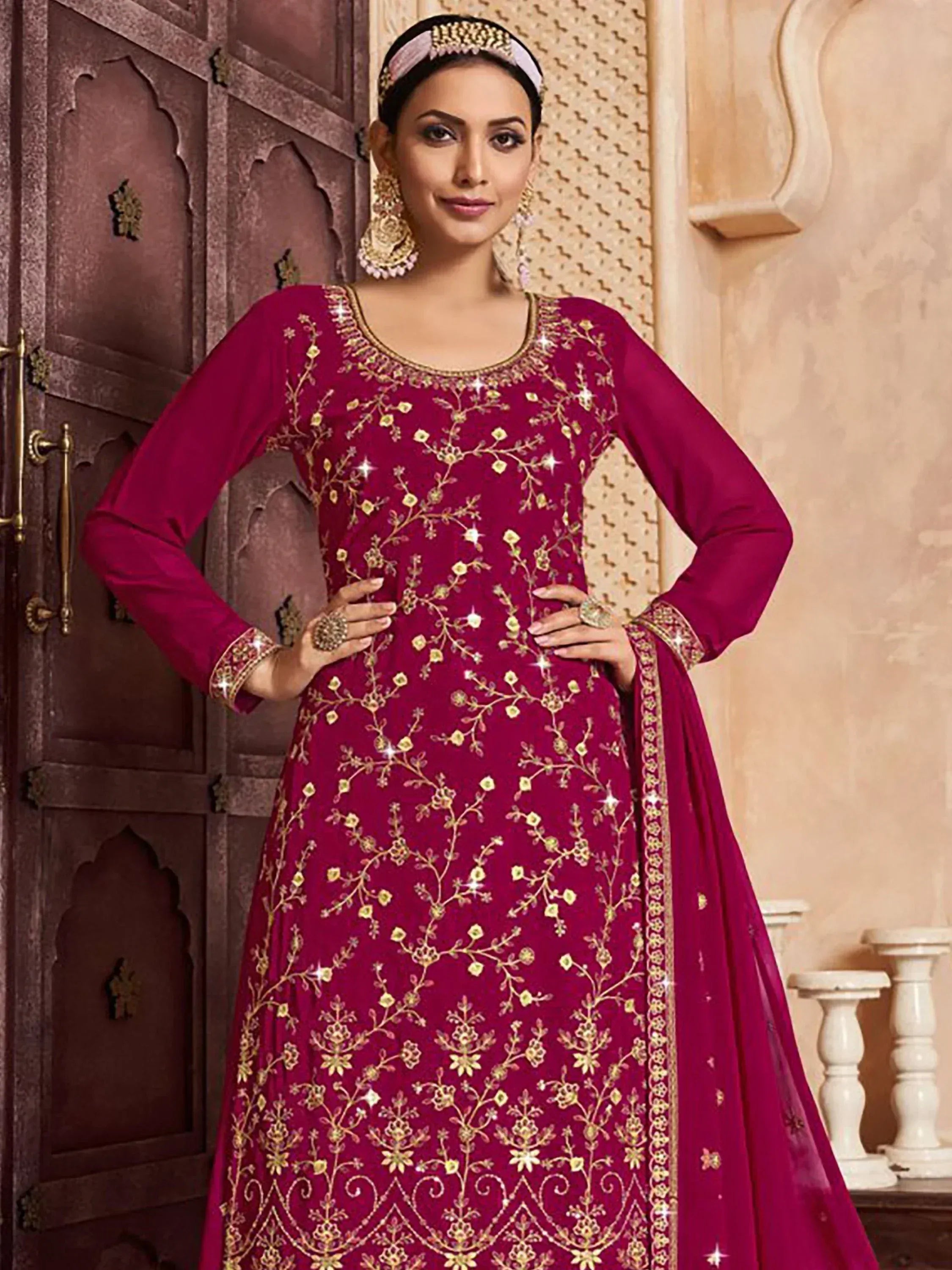 Elegant maroon ethnic gown with gold floral embroidery and embellished neckline, perfect for Indian occasions.