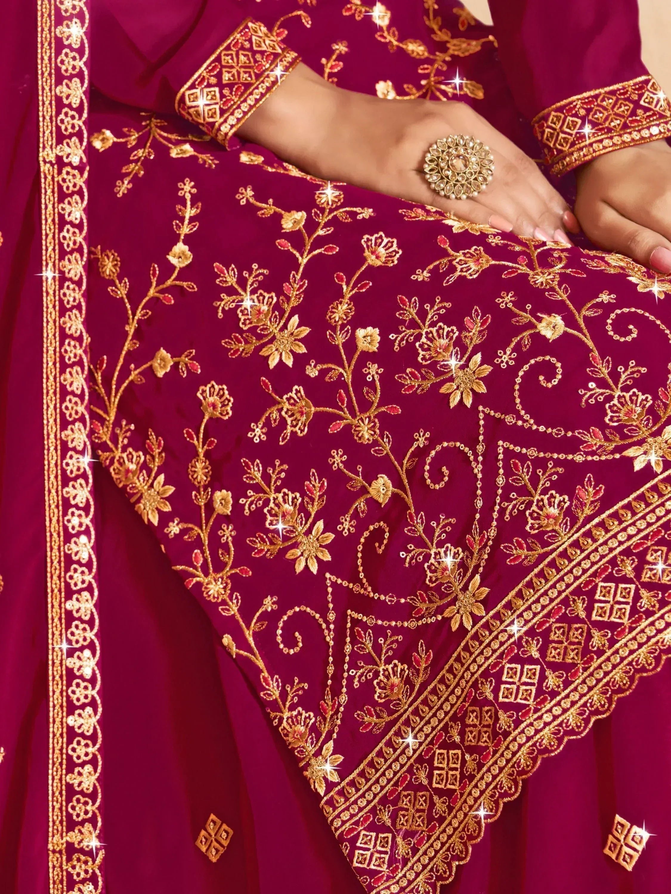 Rich maroon Indian ethnic wear with gold floral embroidery and detailed border, perfect for festive occasions.