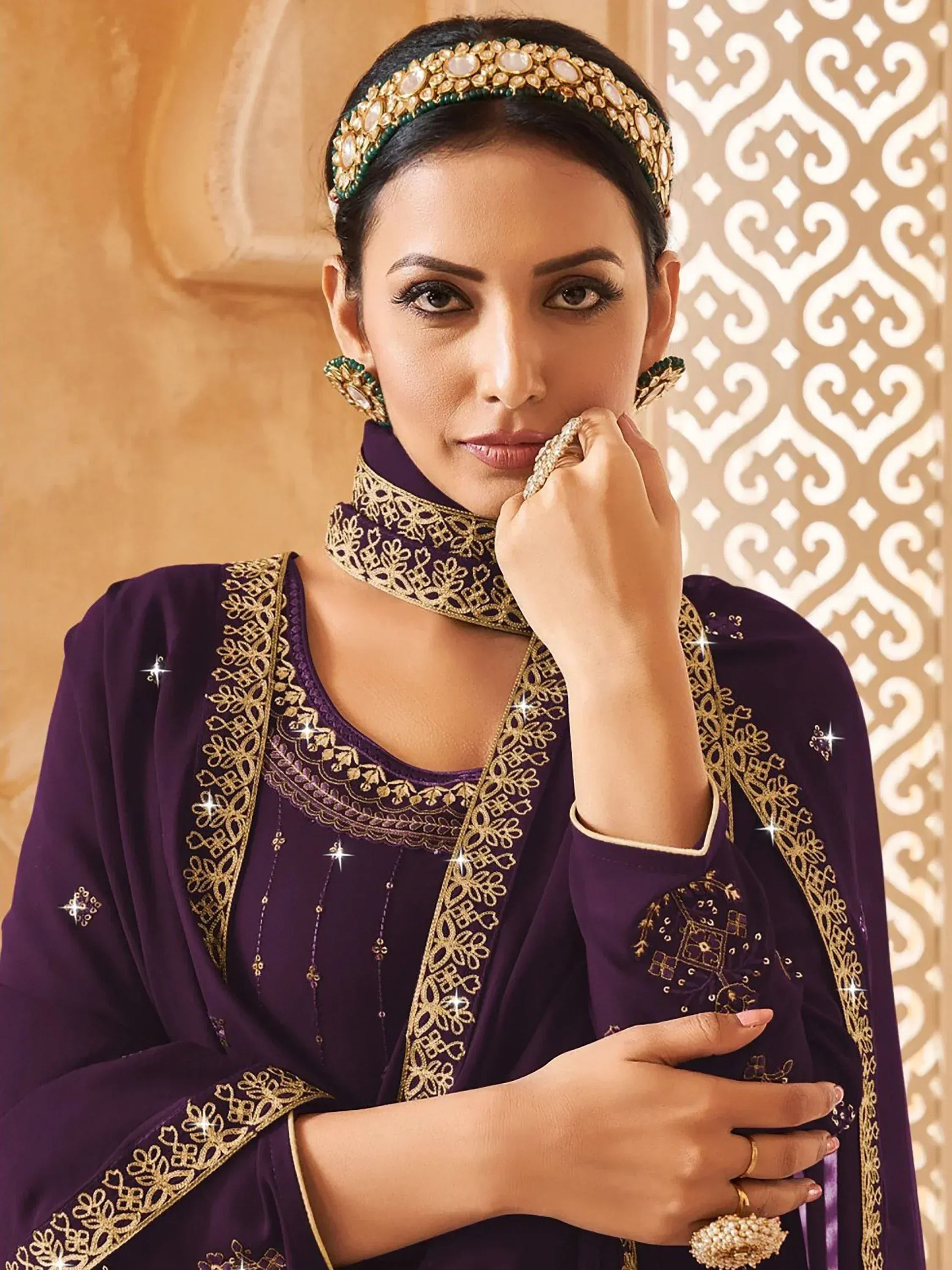 Elegant purple ethnic gown with gold embroidery, perfect for Indian weddings or festive occasions.
