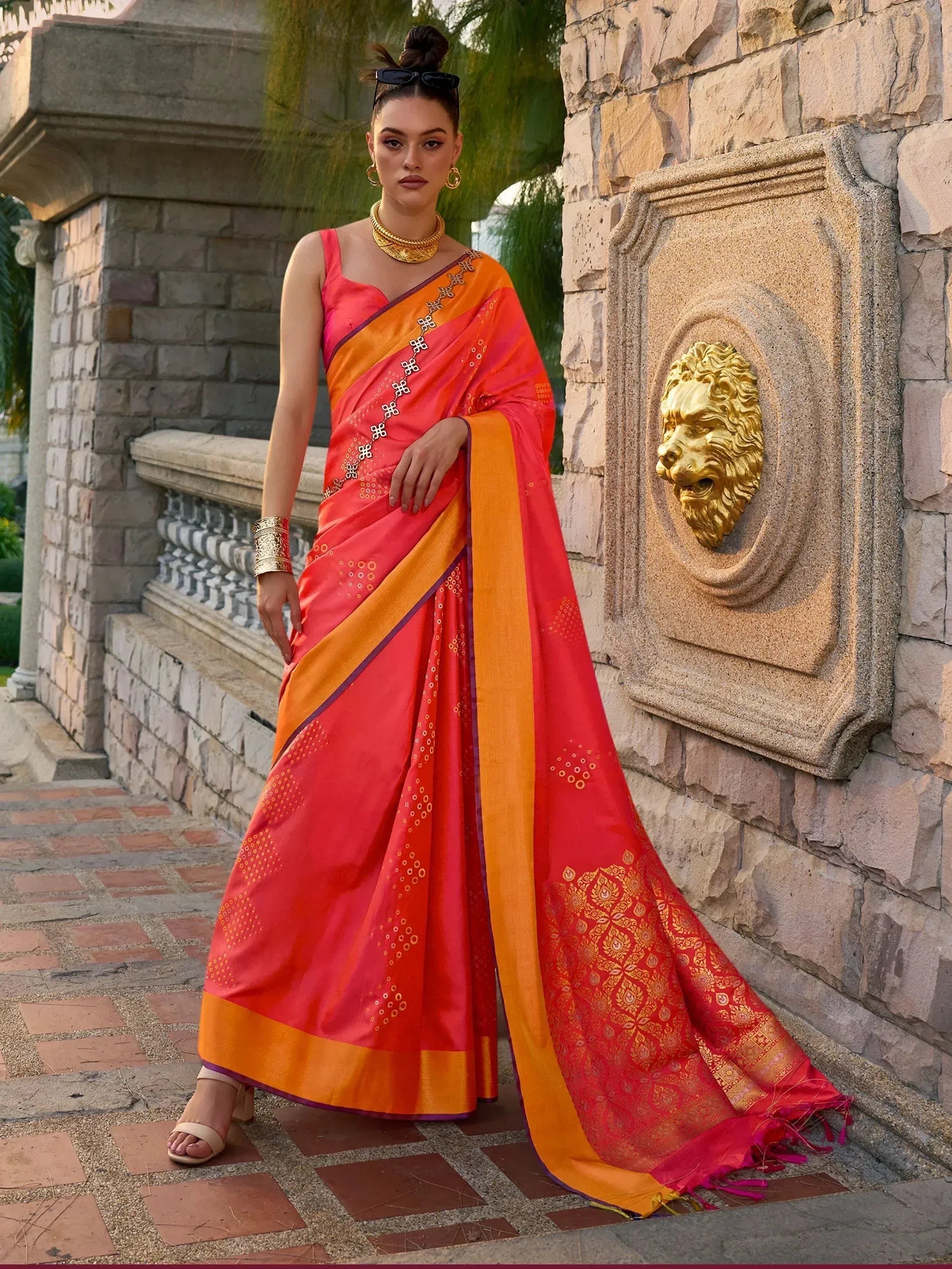 Vibrant red and orange designer saree with gold embroidery, perfect for Indian ethnic wear occasions.