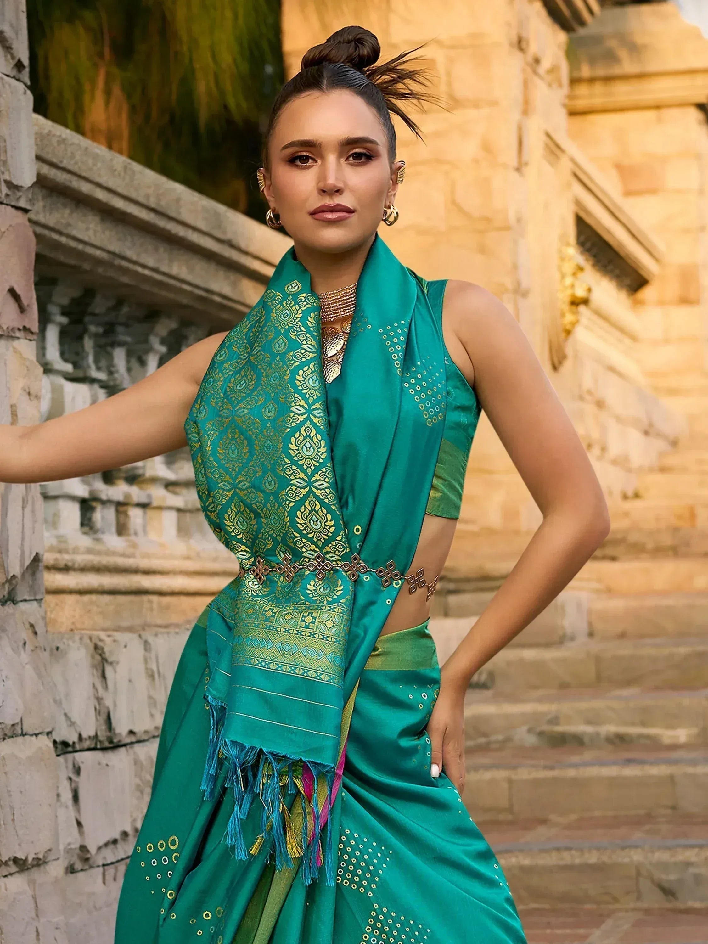 Woman in emerald green ethnic saree with gold embroidery, perfect for Indian festive occasions.