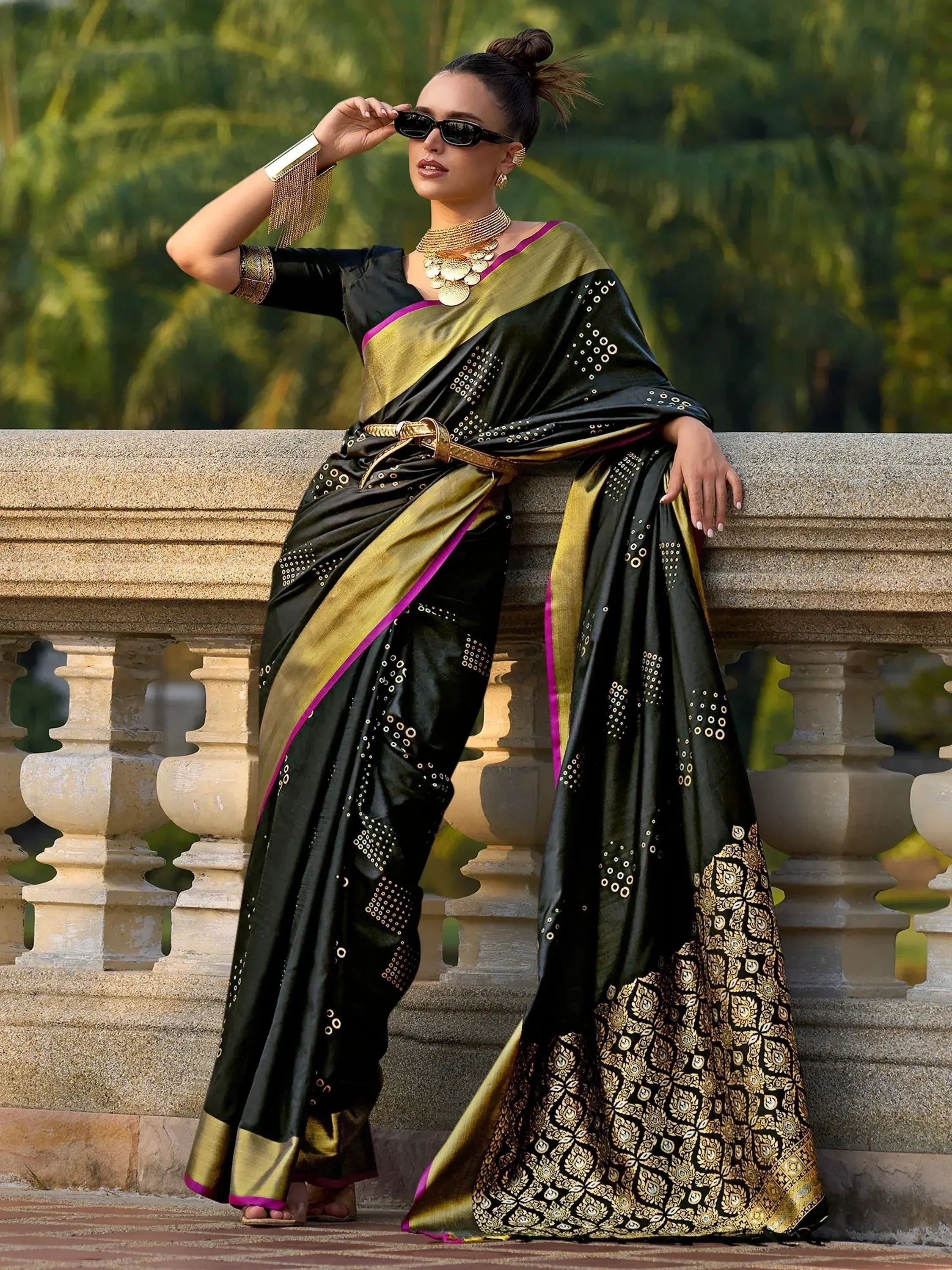 Black and gold designer saree with purple border, perfect for ethnic wear and festive occasions.