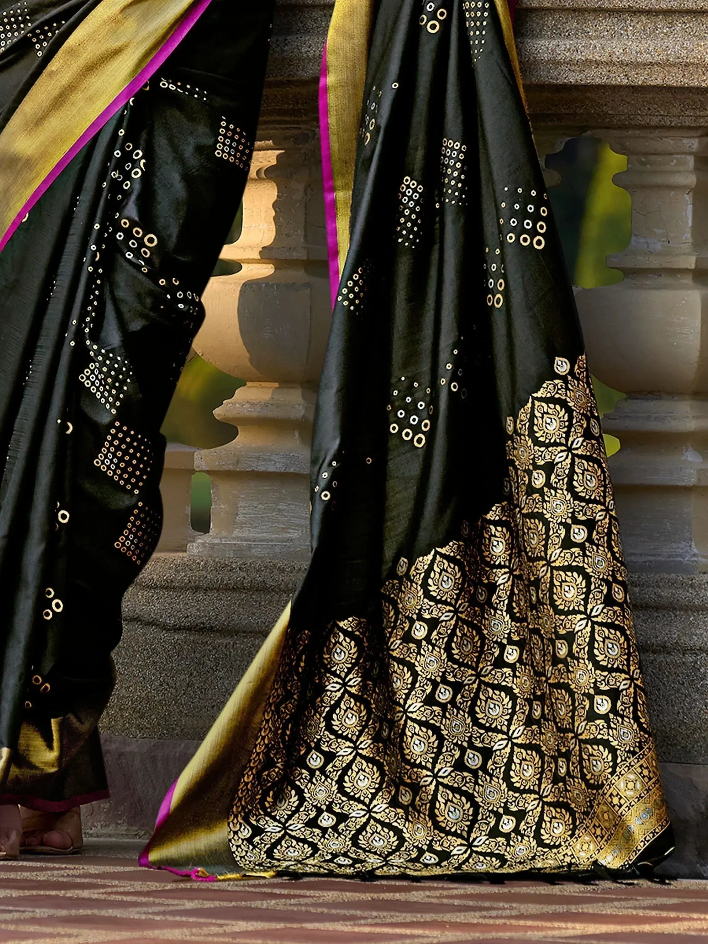 Black and gold designer saree with intricate patterns and purple border, perfect for ethnic occasions