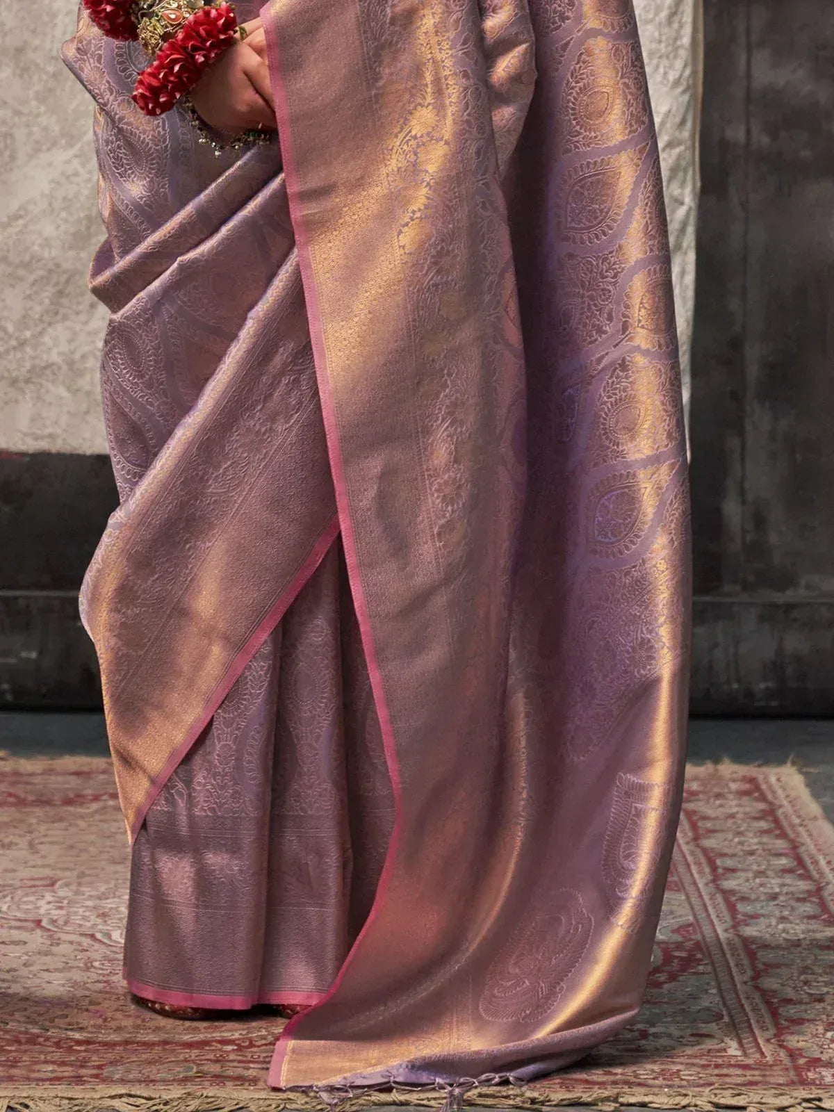 Elegant purple and gold paisley saree with pink border, perfect for Indian ethnic occasions