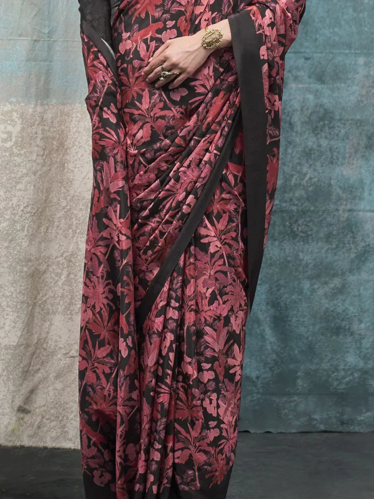 Black and pink floral print saree with elegant drape, perfect for ethnic occasions