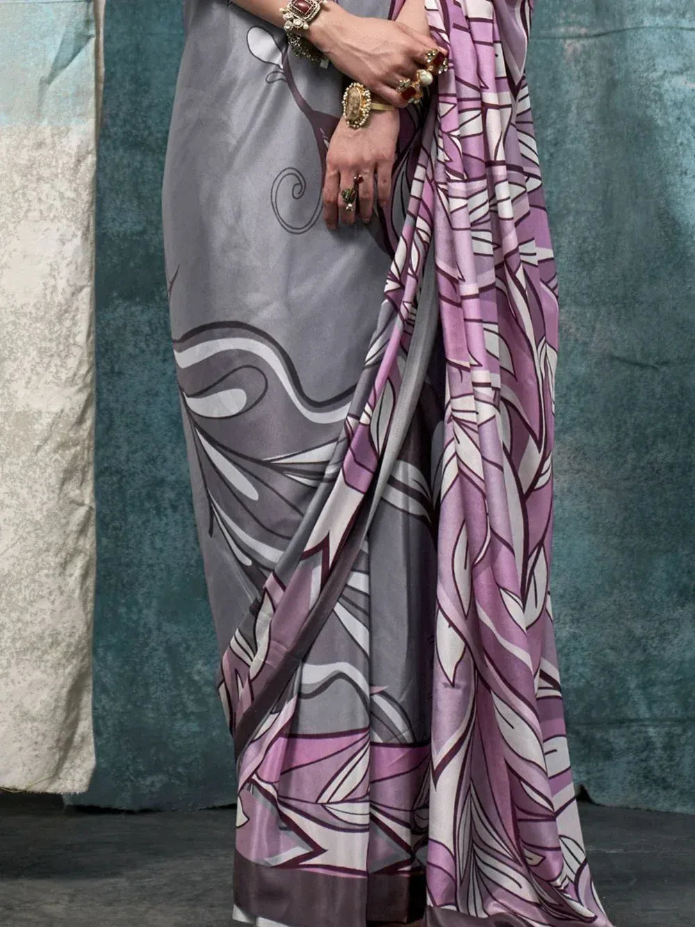 Grey and purple printed saree with abstract leaf pattern, styled with ethnic jewelry for Indian ethnic wear