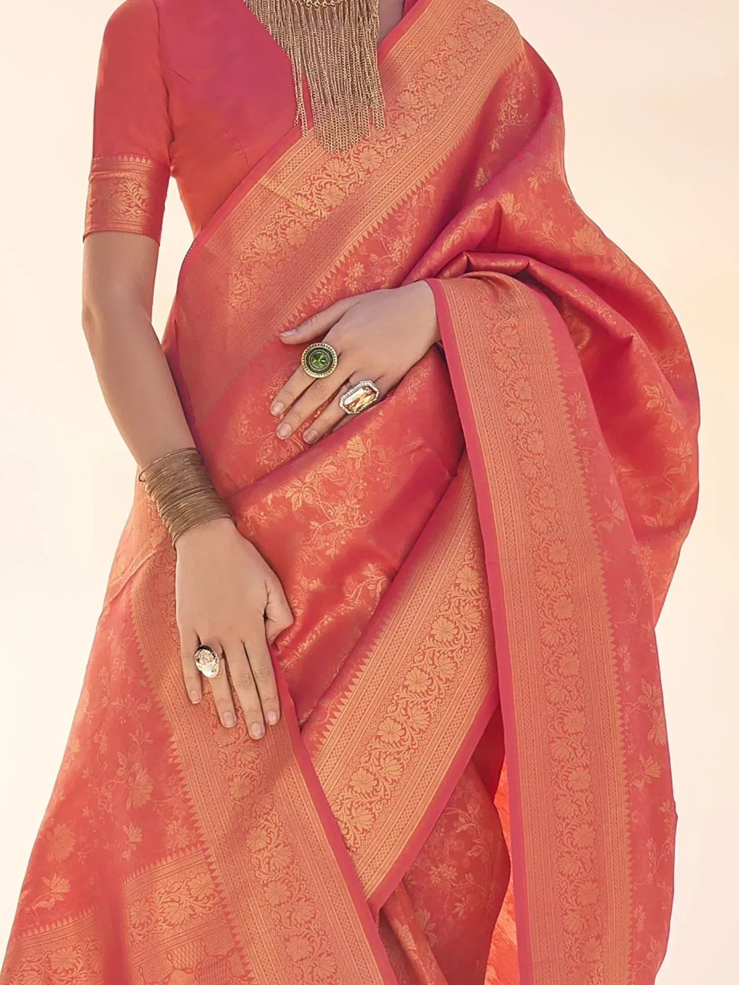 Coral pink designer saree with gold floral zari work, perfect for Indian ethnic wear occasions