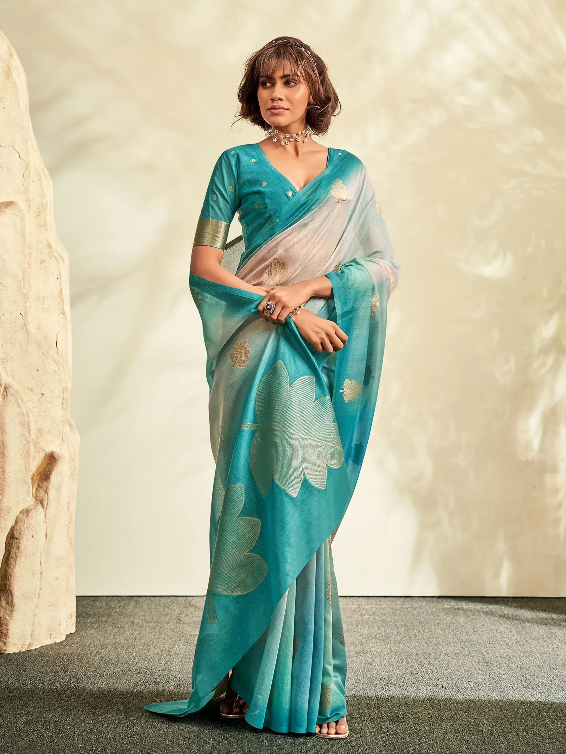 Teal and silver designer saree with leaf motifs, perfect for Indian ethnic wear occasions